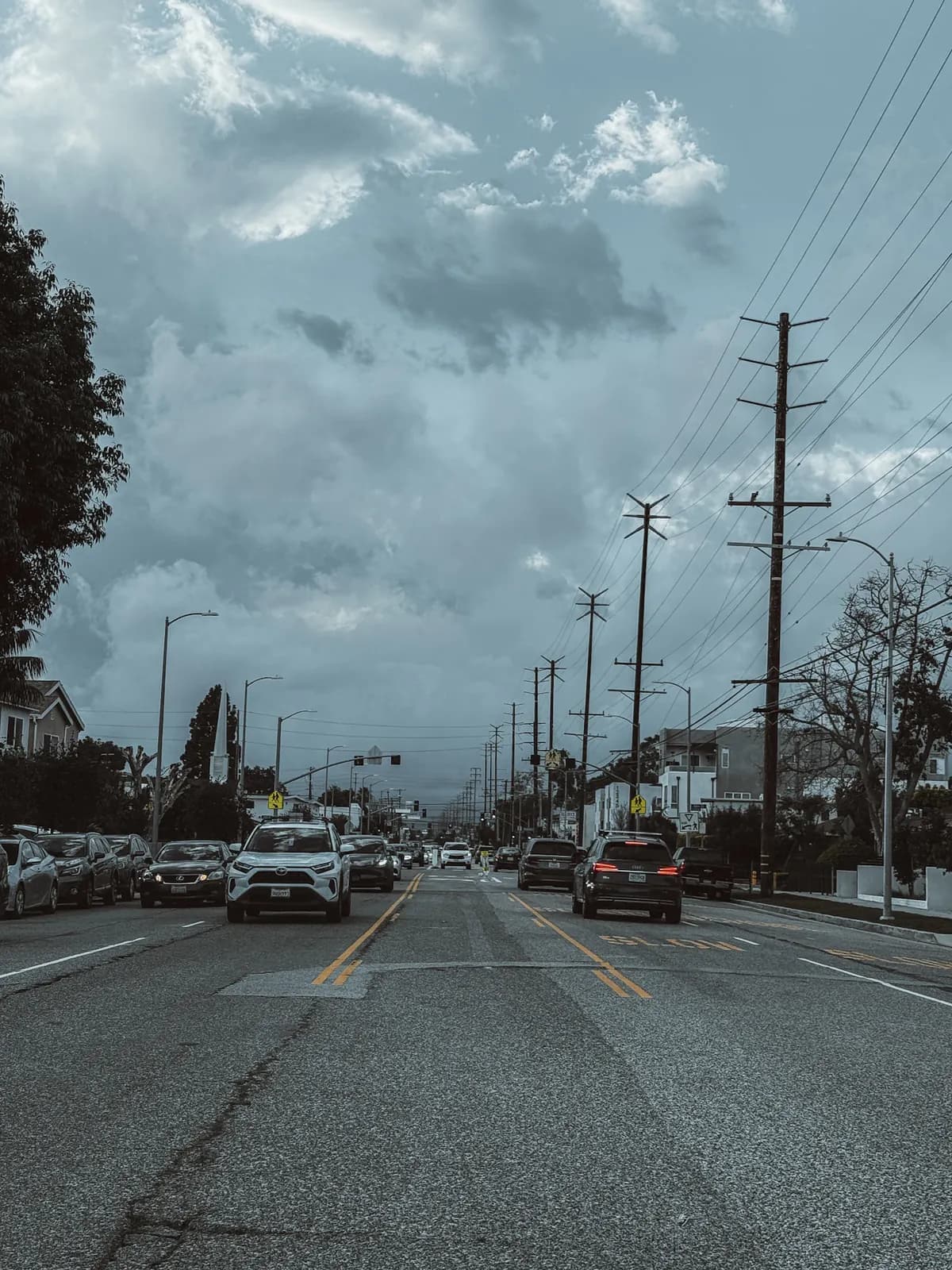 A lived-in Culver City street beneath textured storm clouds