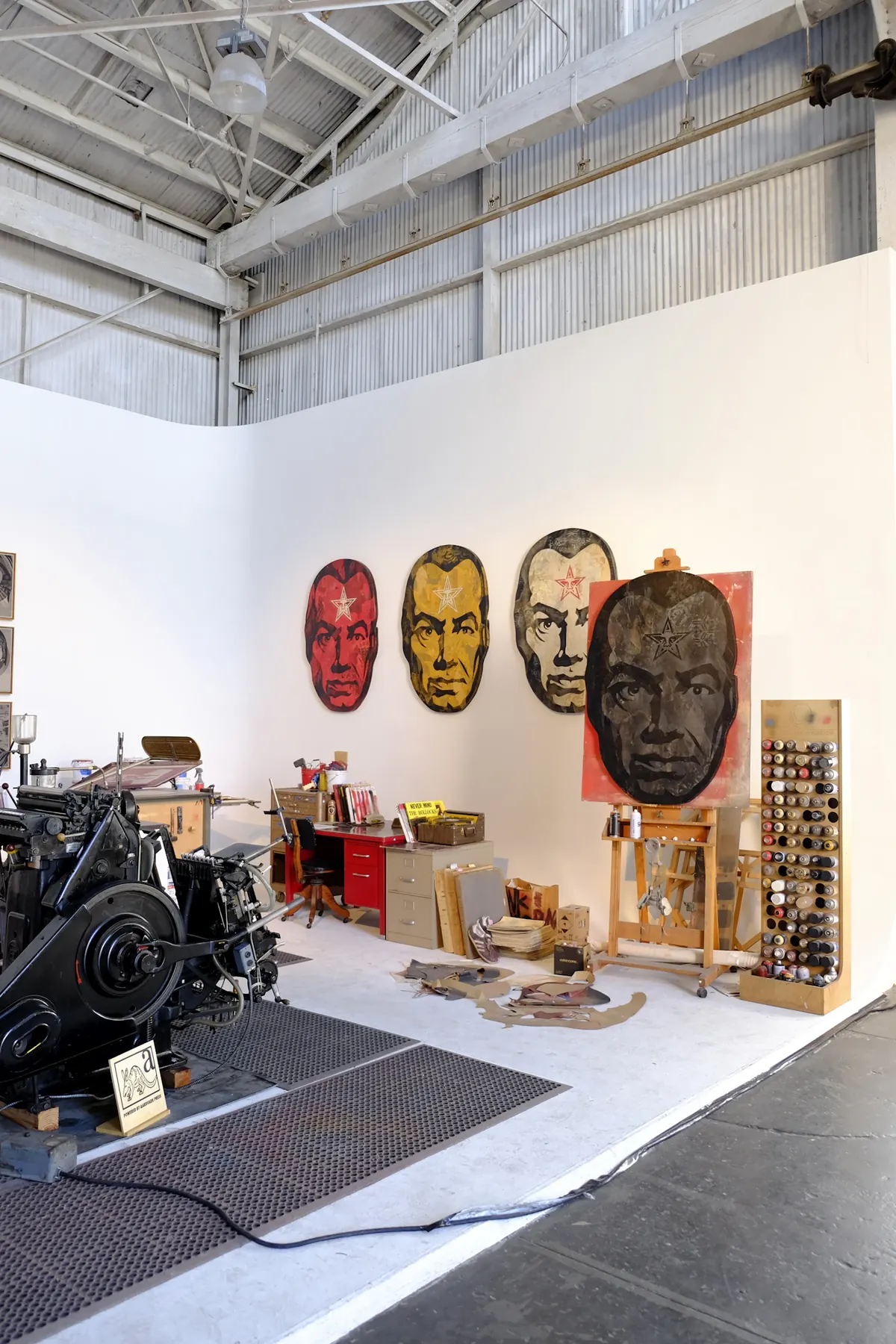 A Culver City gallery installation with portrait art and sculptural objects