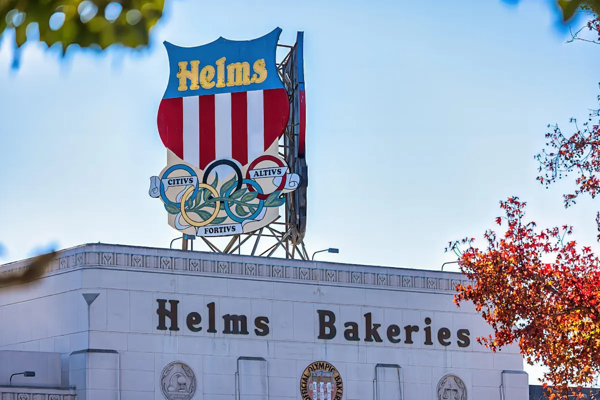 The historic Helms Bakeries sign above the white bakery building