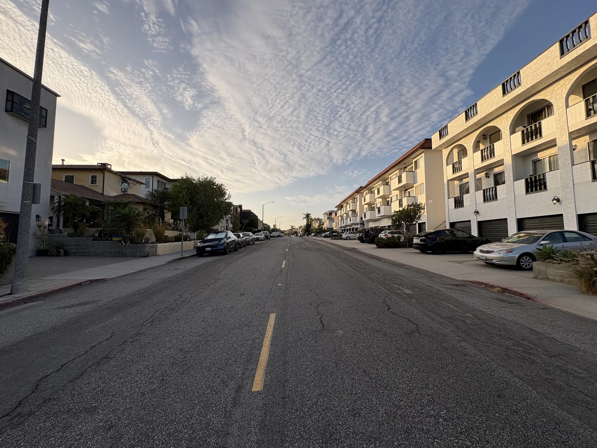 A broad coastal residential block lined with apartments and townhomes