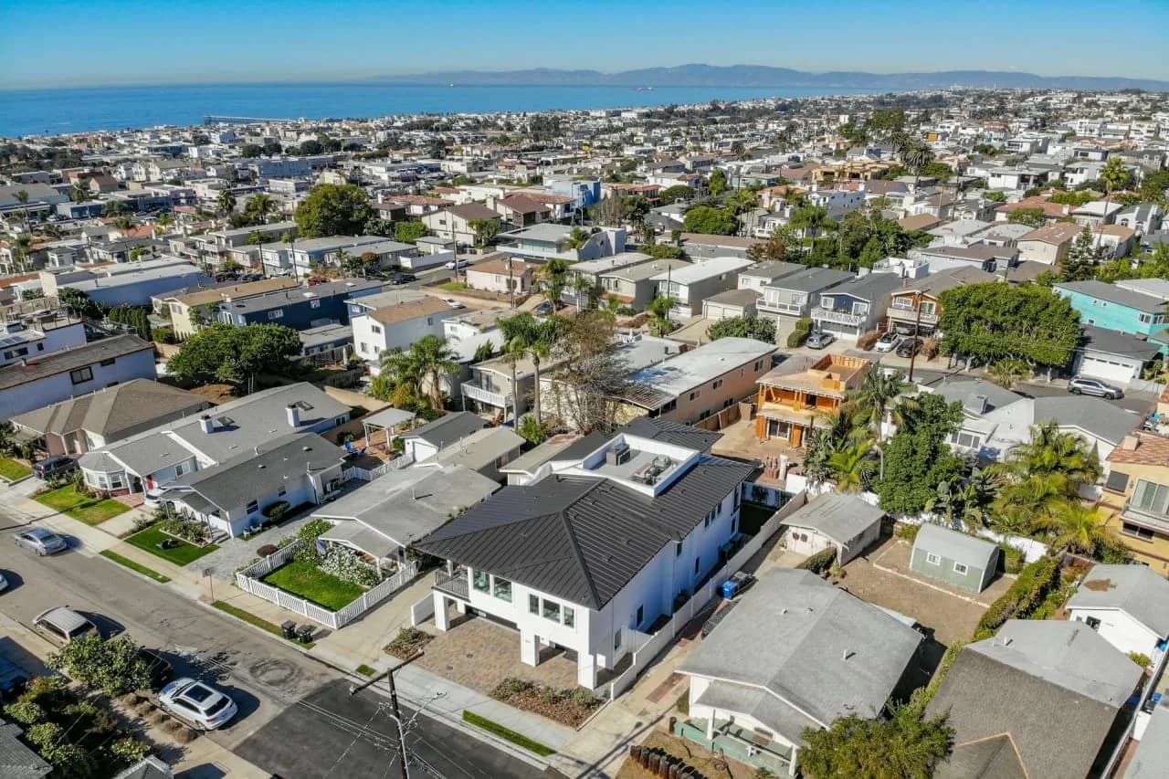 Aerial view across homes in Hermosa Hills toward the ocean