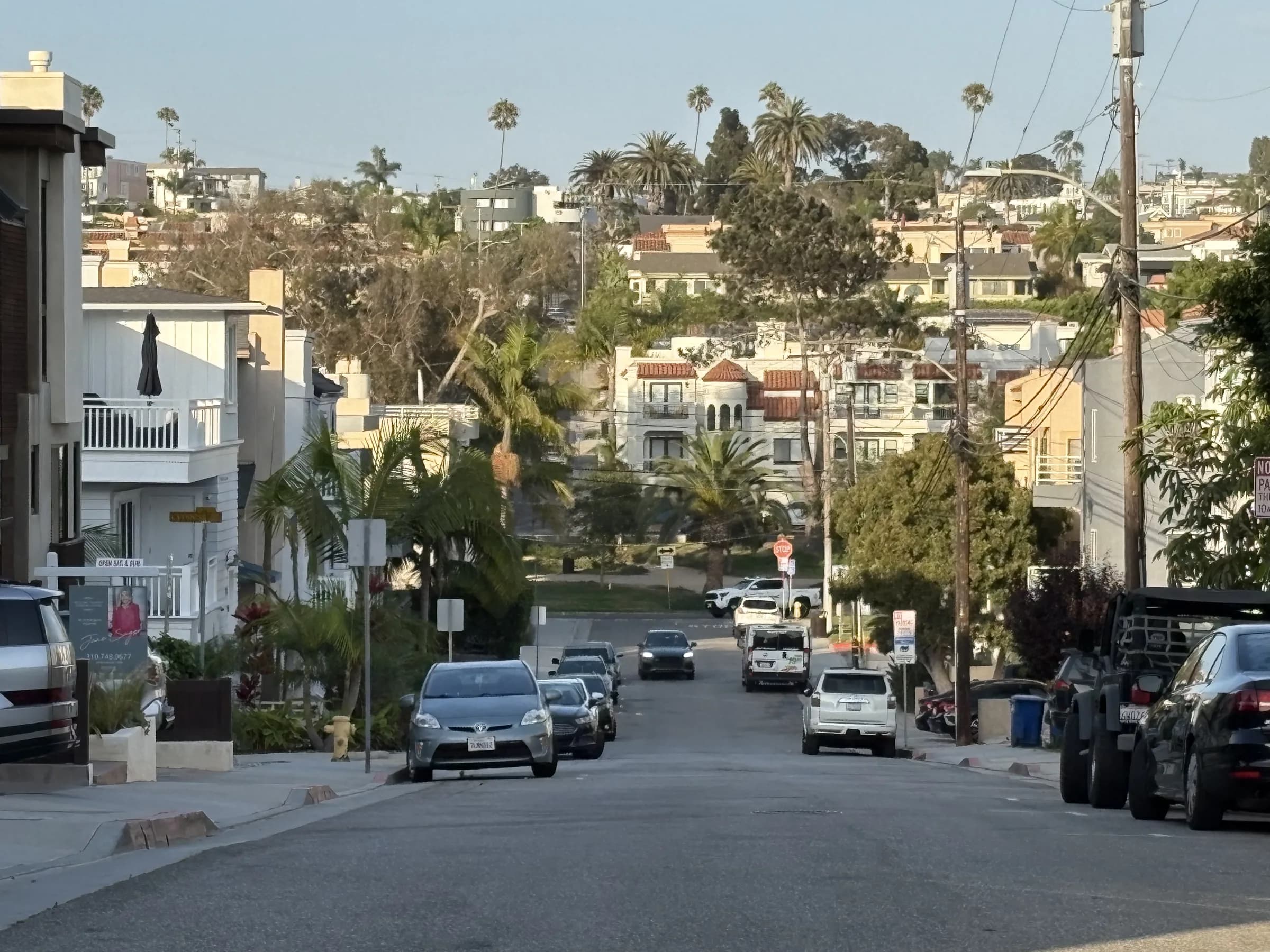 A long downhill view through a hillside Hermosa Beach neighborhood