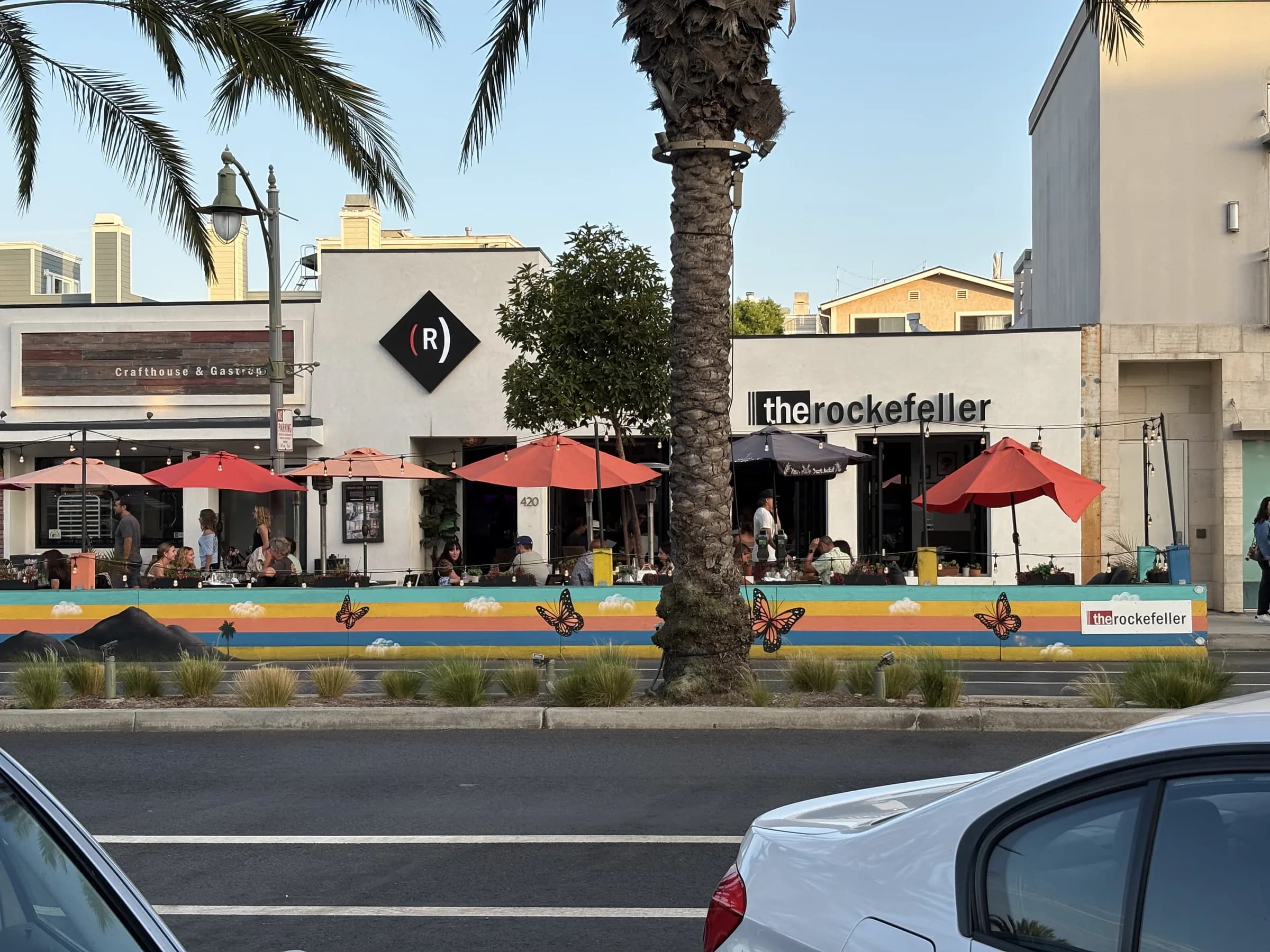 A local restaurant patio and neighboring businesses along Pier Avenue