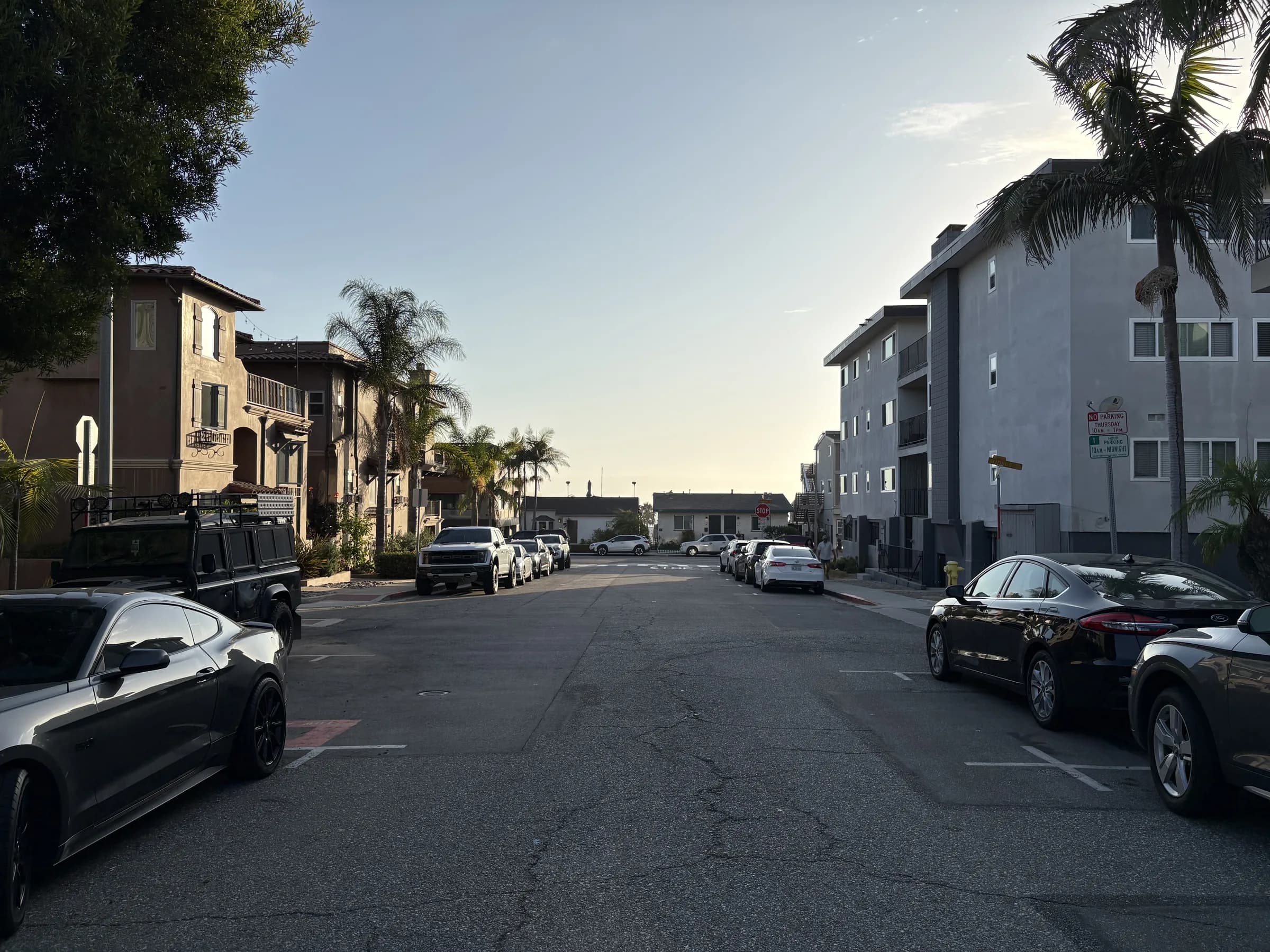 A residential street descending toward the ocean in Hermosa Beach