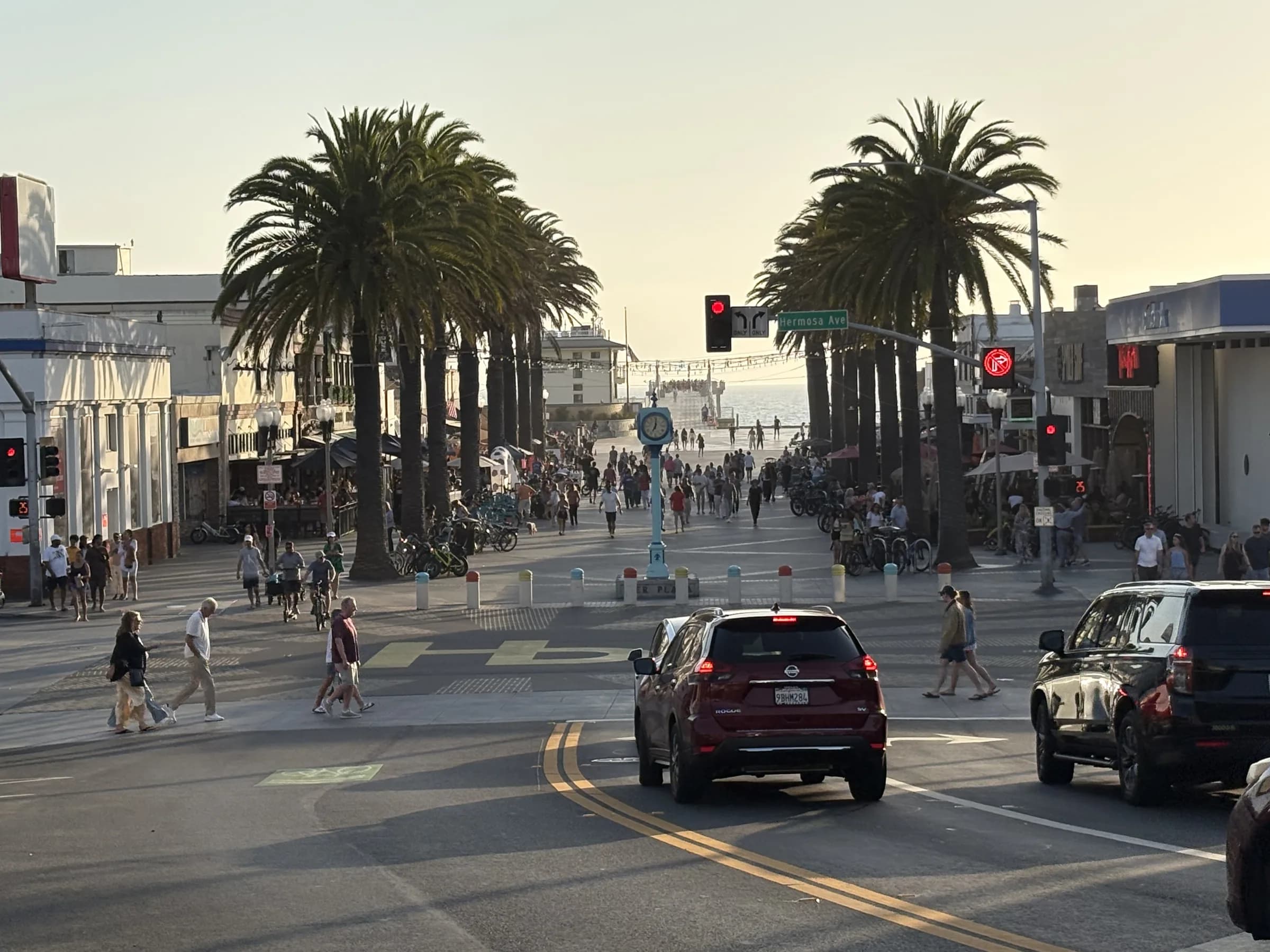 Pier Avenue leading through palm trees toward the Pacific Ocean