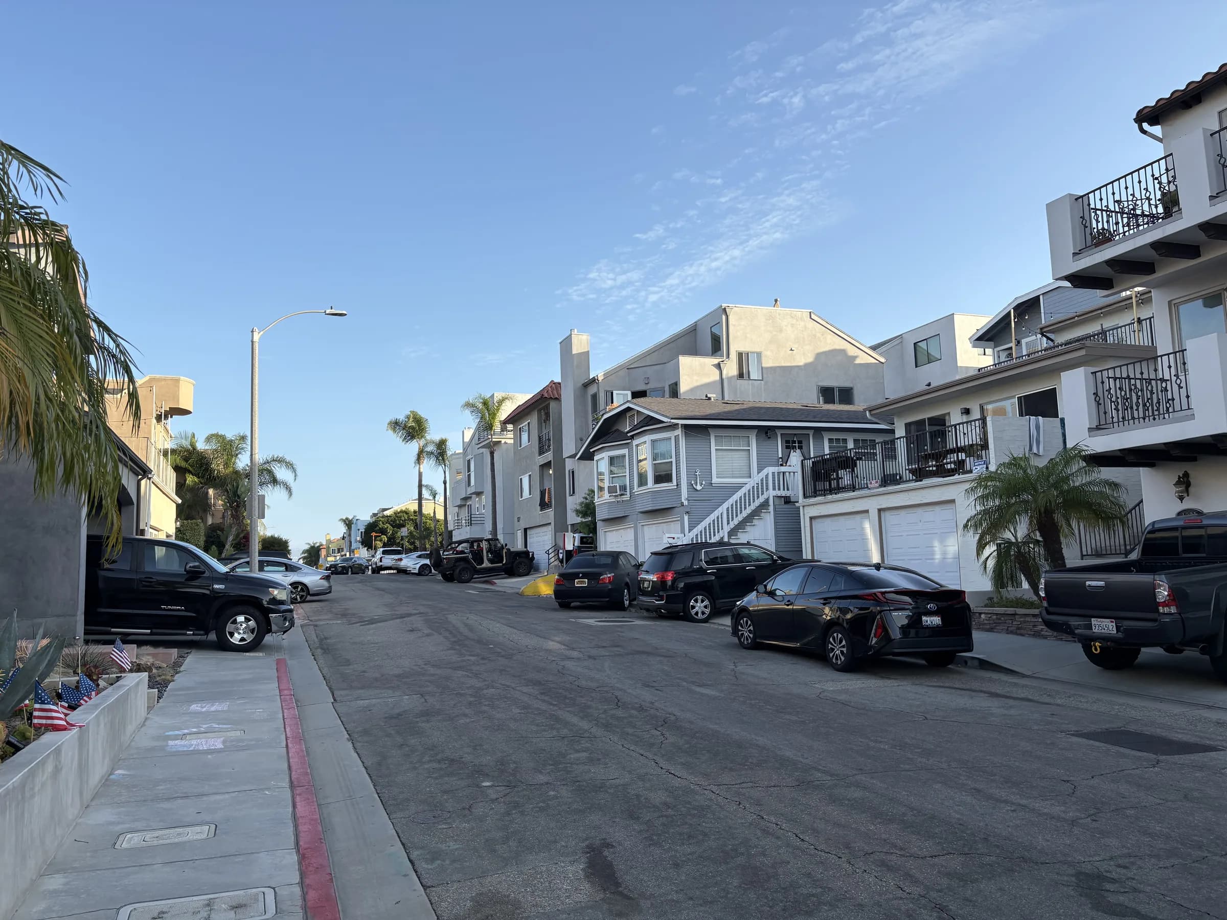 A broad street lined with white Sand Section residences