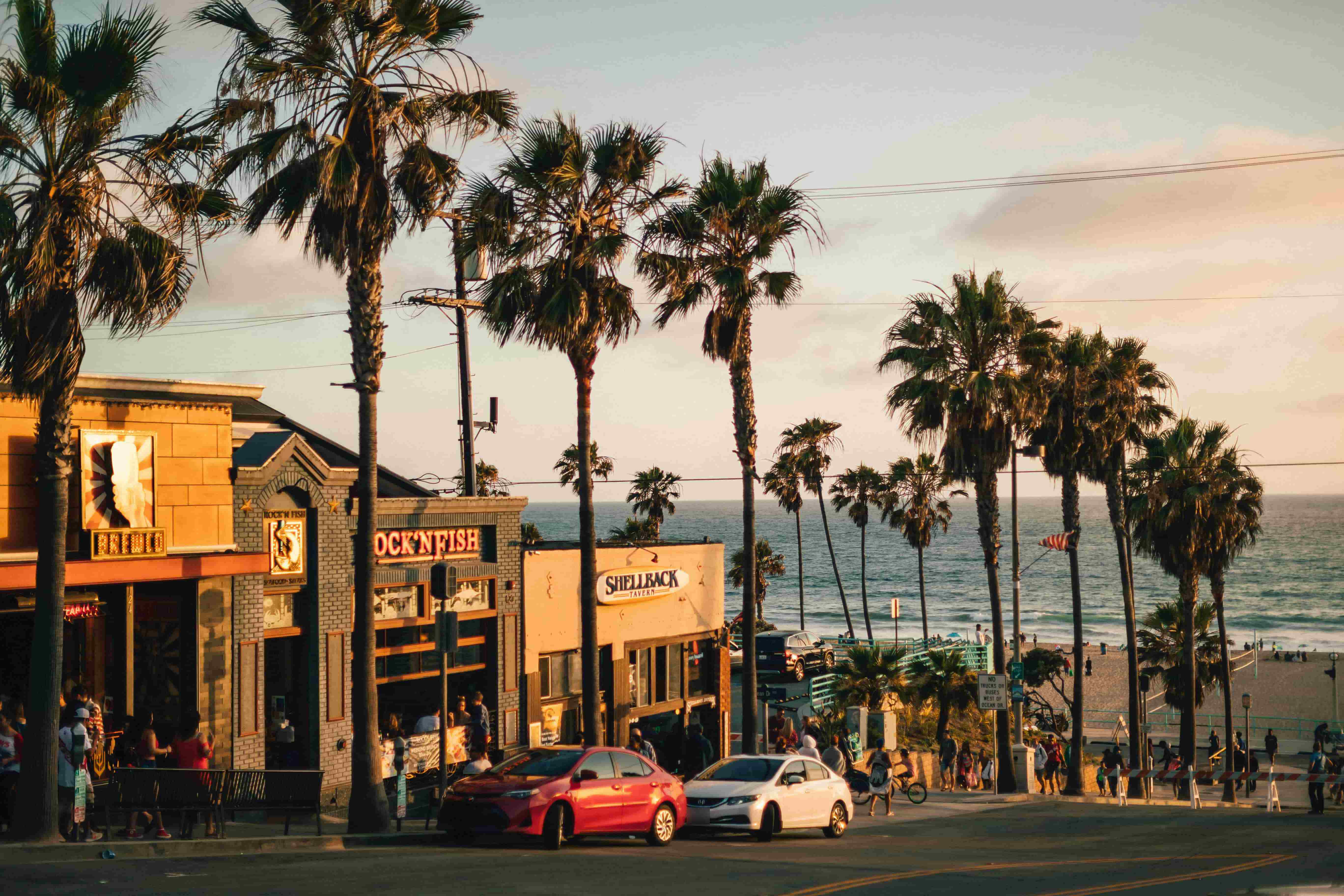Downtown Manhattan Beach storefronts along a palm-lined street