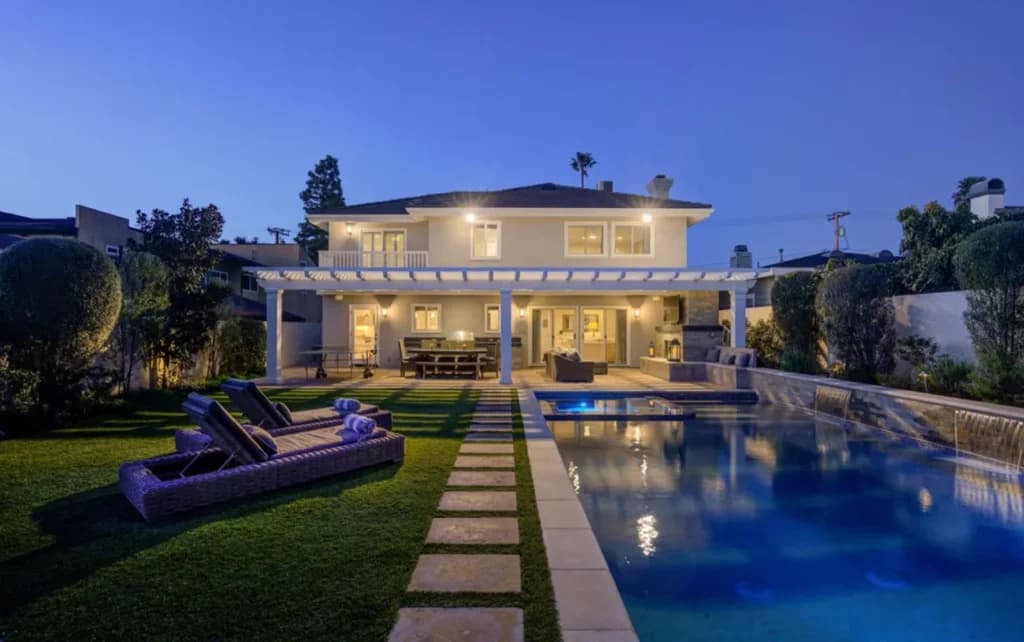 Modern Manhattan Beach home with a pool at dusk