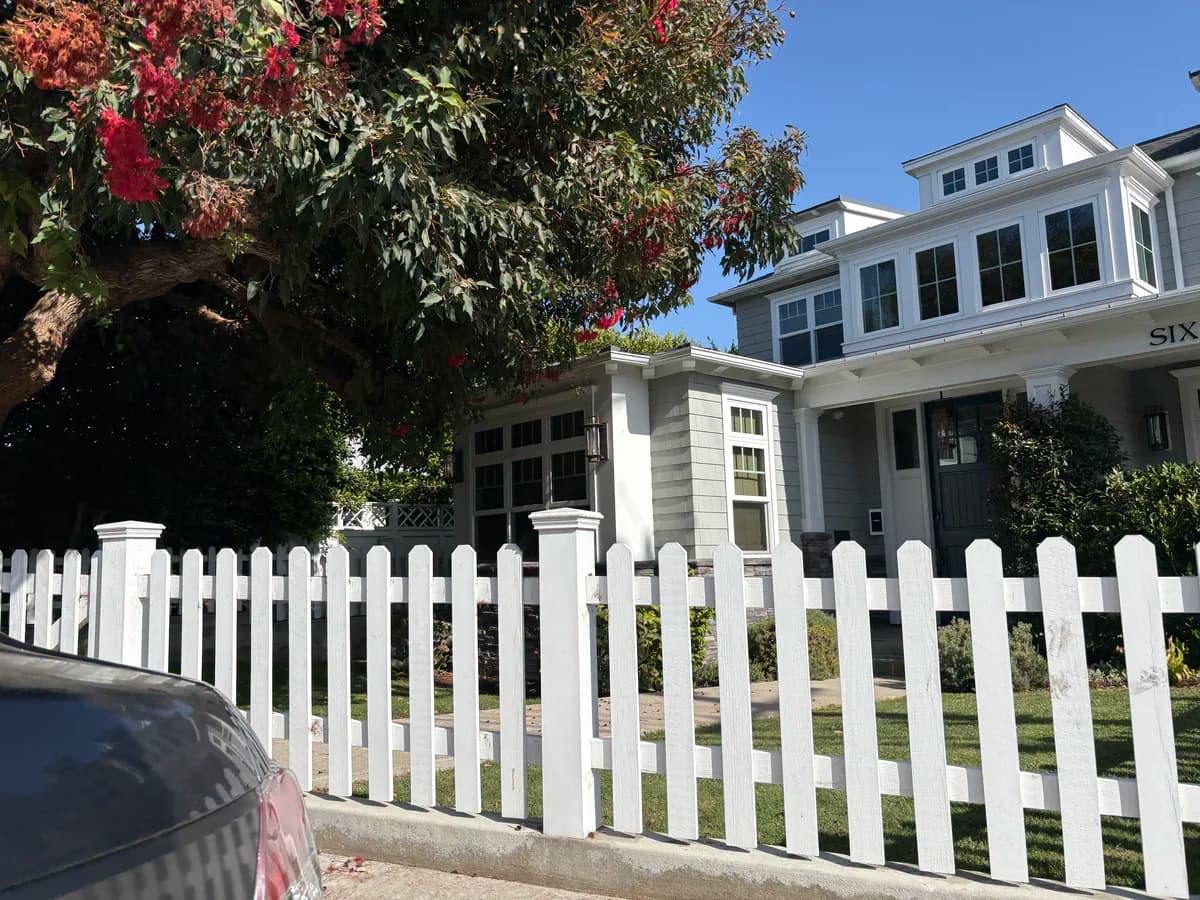 Gray shingle home with a white picket fence in Manhattan Beach