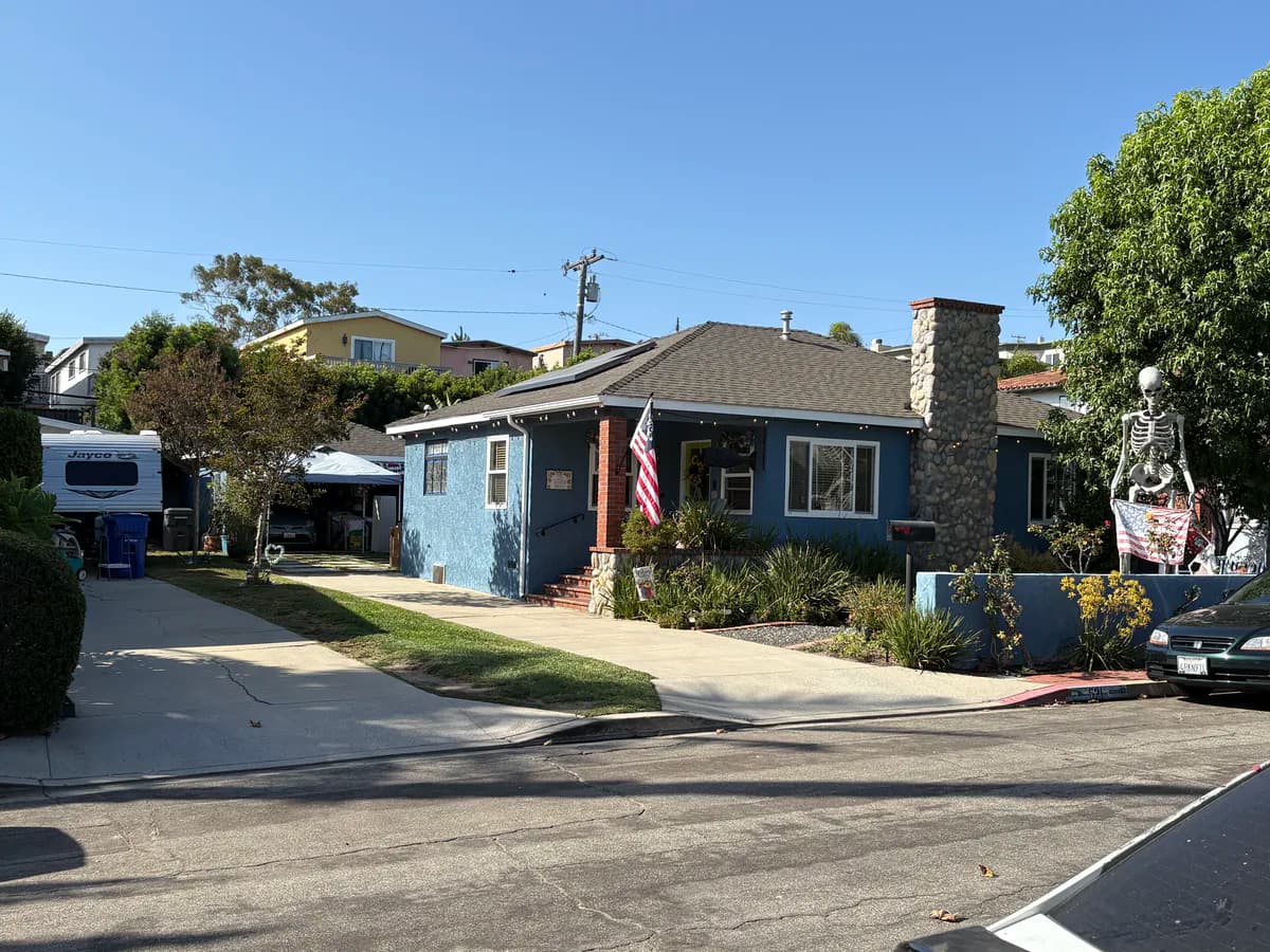 Single-story blue home on a quiet Manhattan Beach street