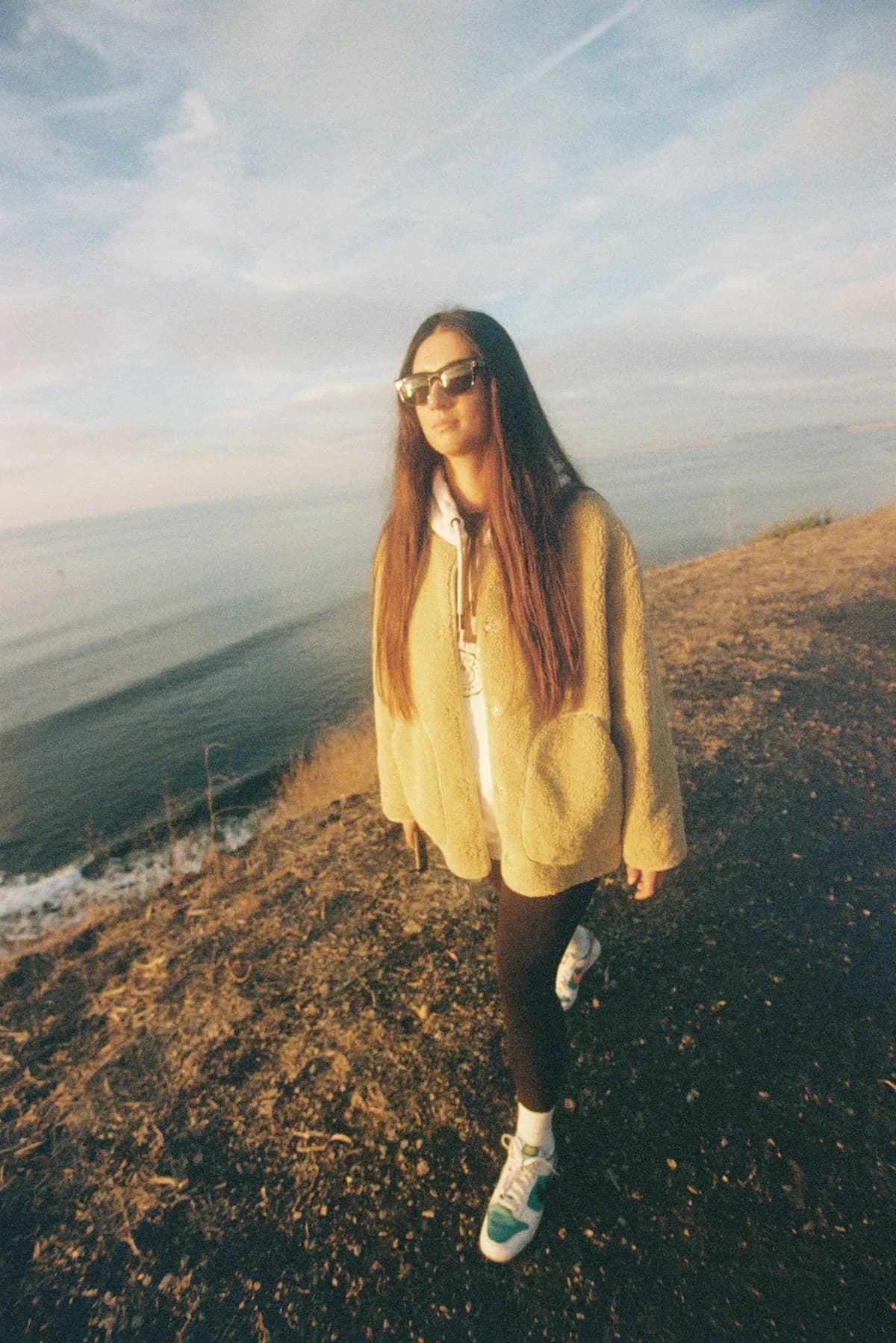 A walker enjoying golden-hour light on a Palos Verdes bluff path