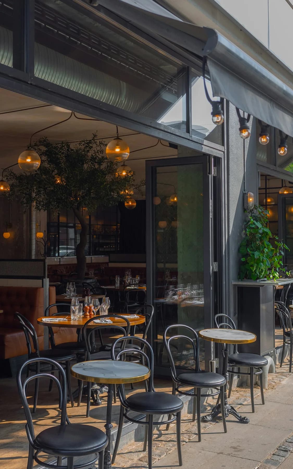 A welcoming streetfront cafe with tables set outside