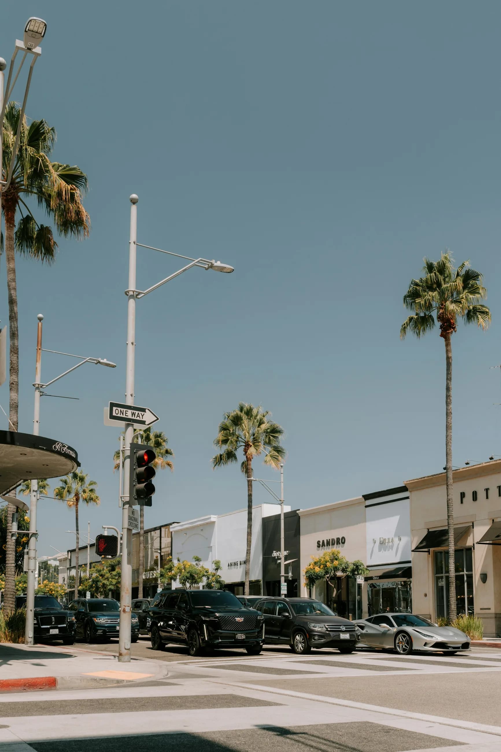 A contemporary Beverly Hills retail street beneath a soft evening sky
