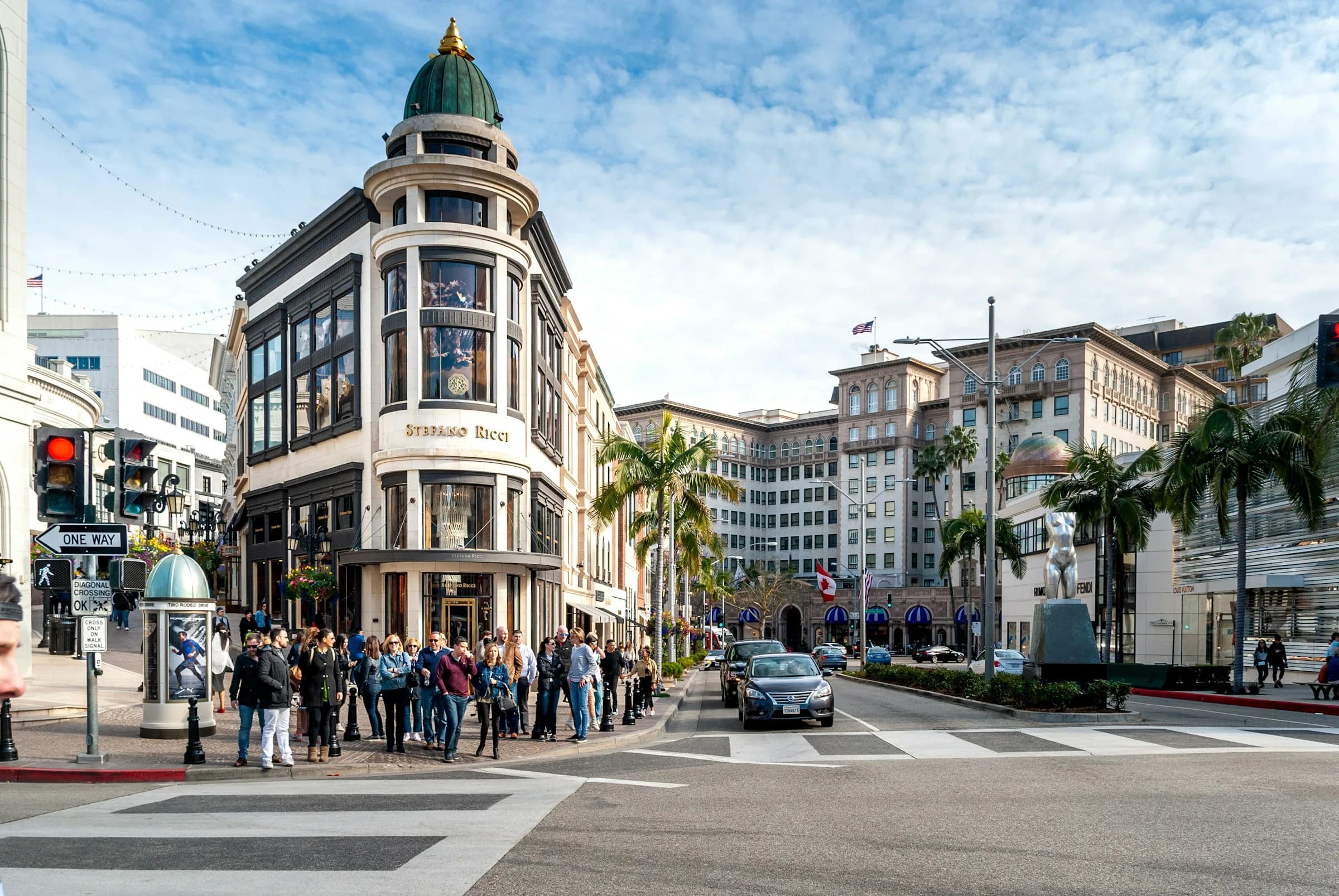 Pedestrians crossing a busy Beverly Hills shopping corner