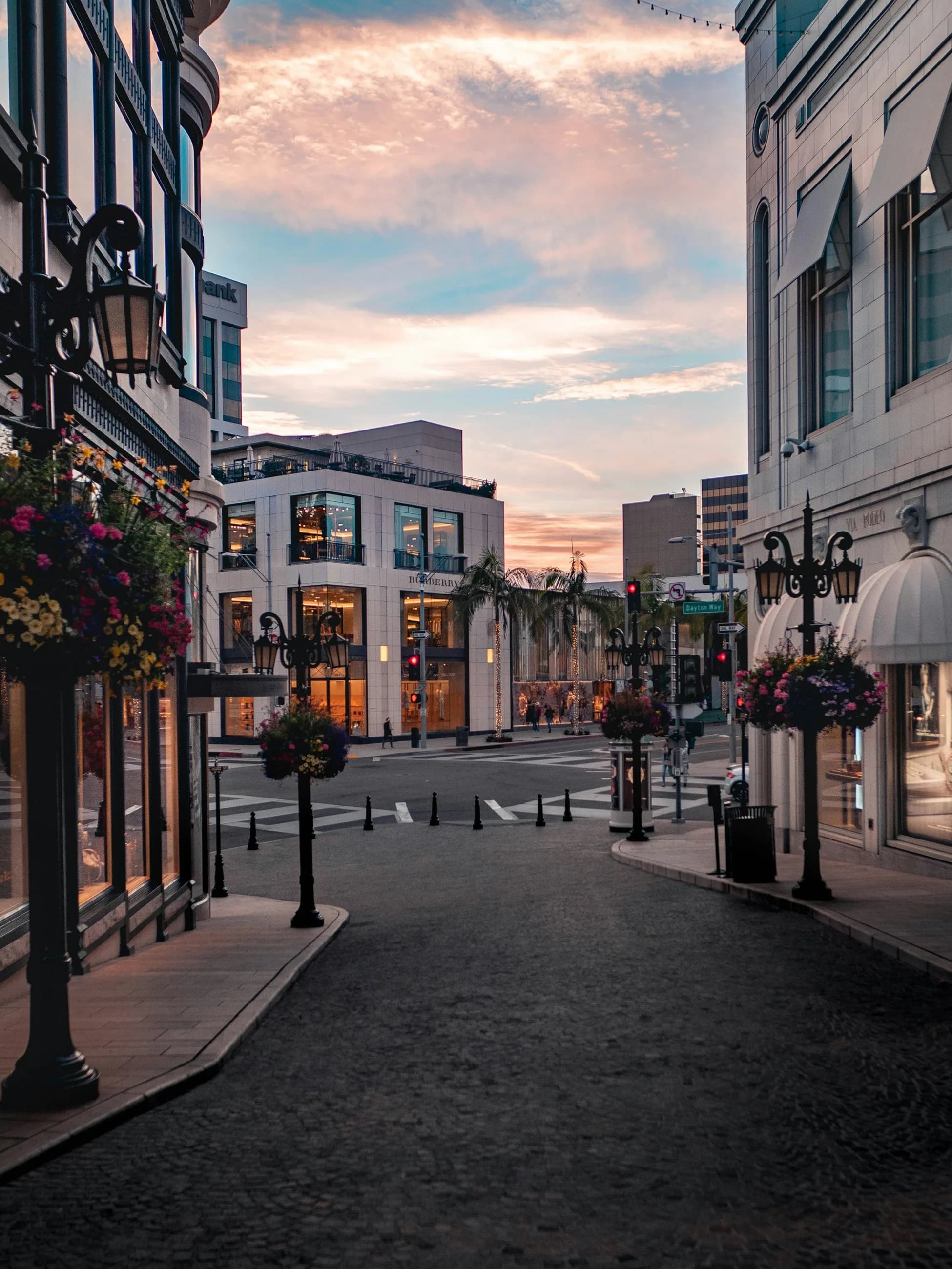 A quiet Rodeo Drive side street beneath a warm sunset sky