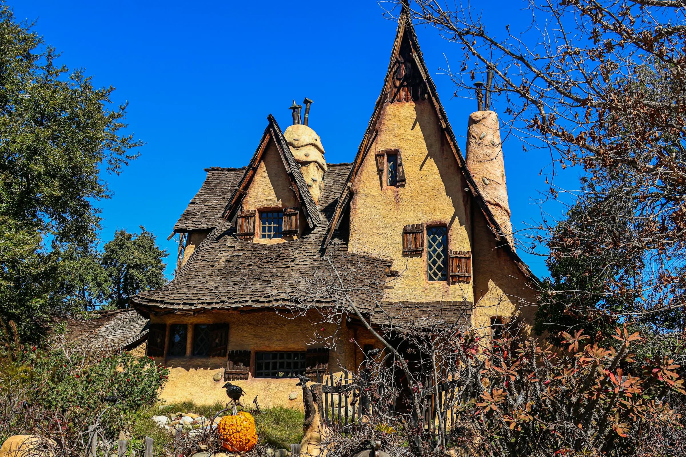 The whimsical historic Spadena House behind its garden in Beverly Hills