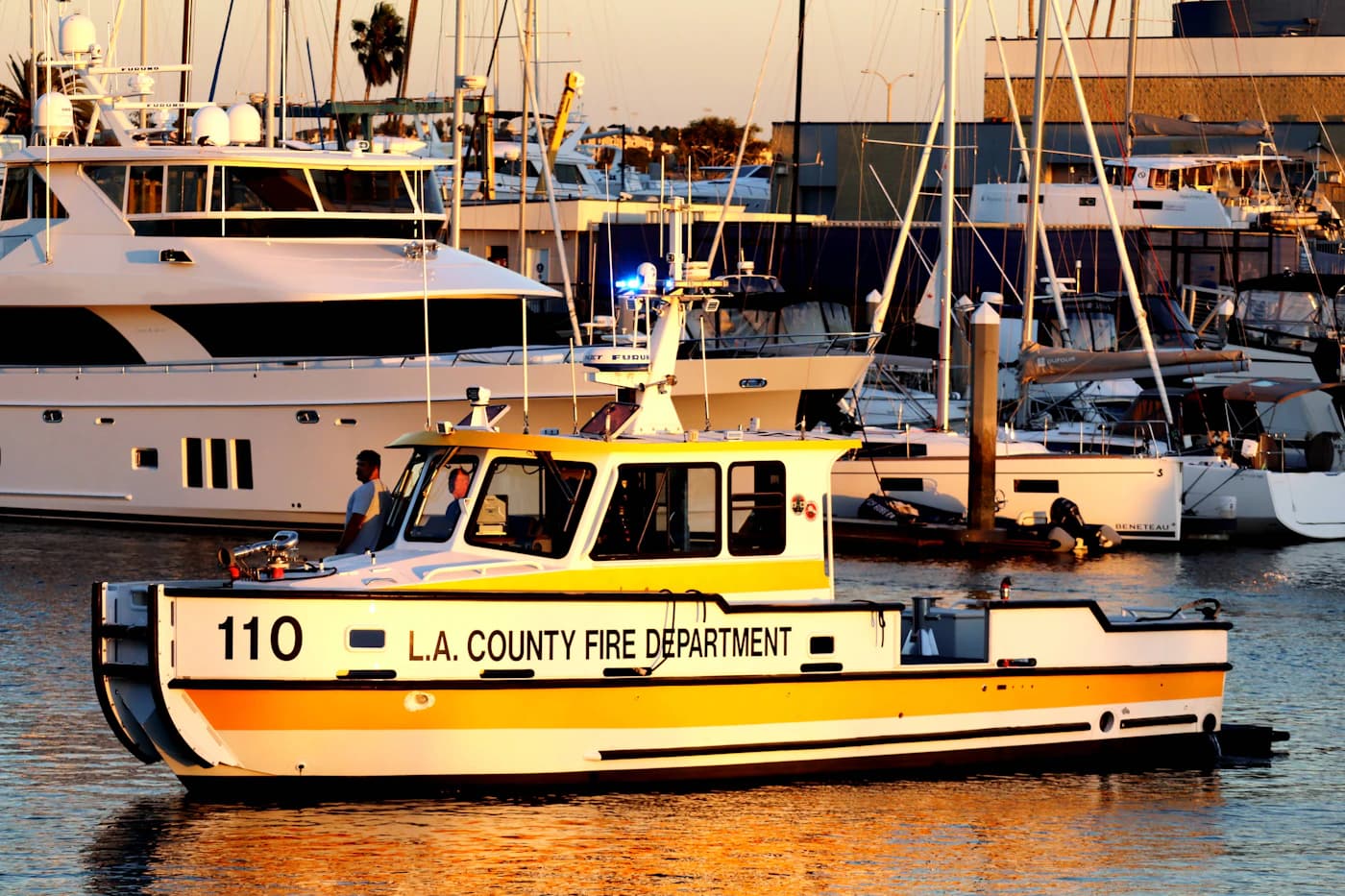 An LA County fireboat passing yachts beside Burton Chace Park