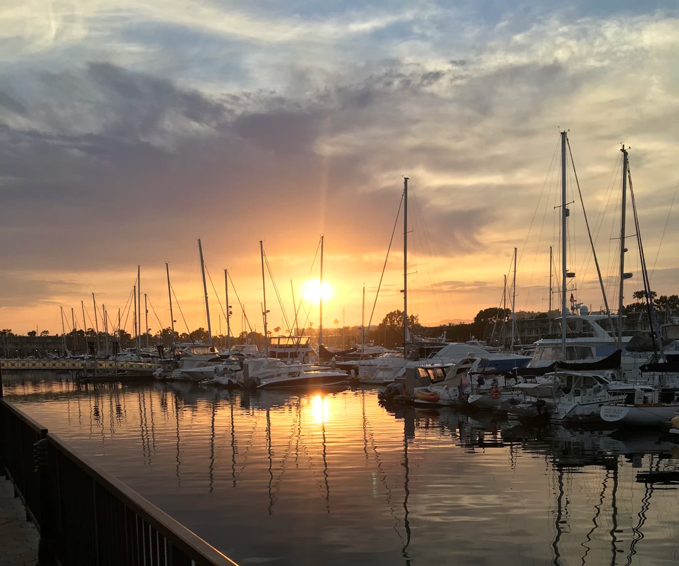 Warm sunset light reflecting across boats in Marina del Rey harbor