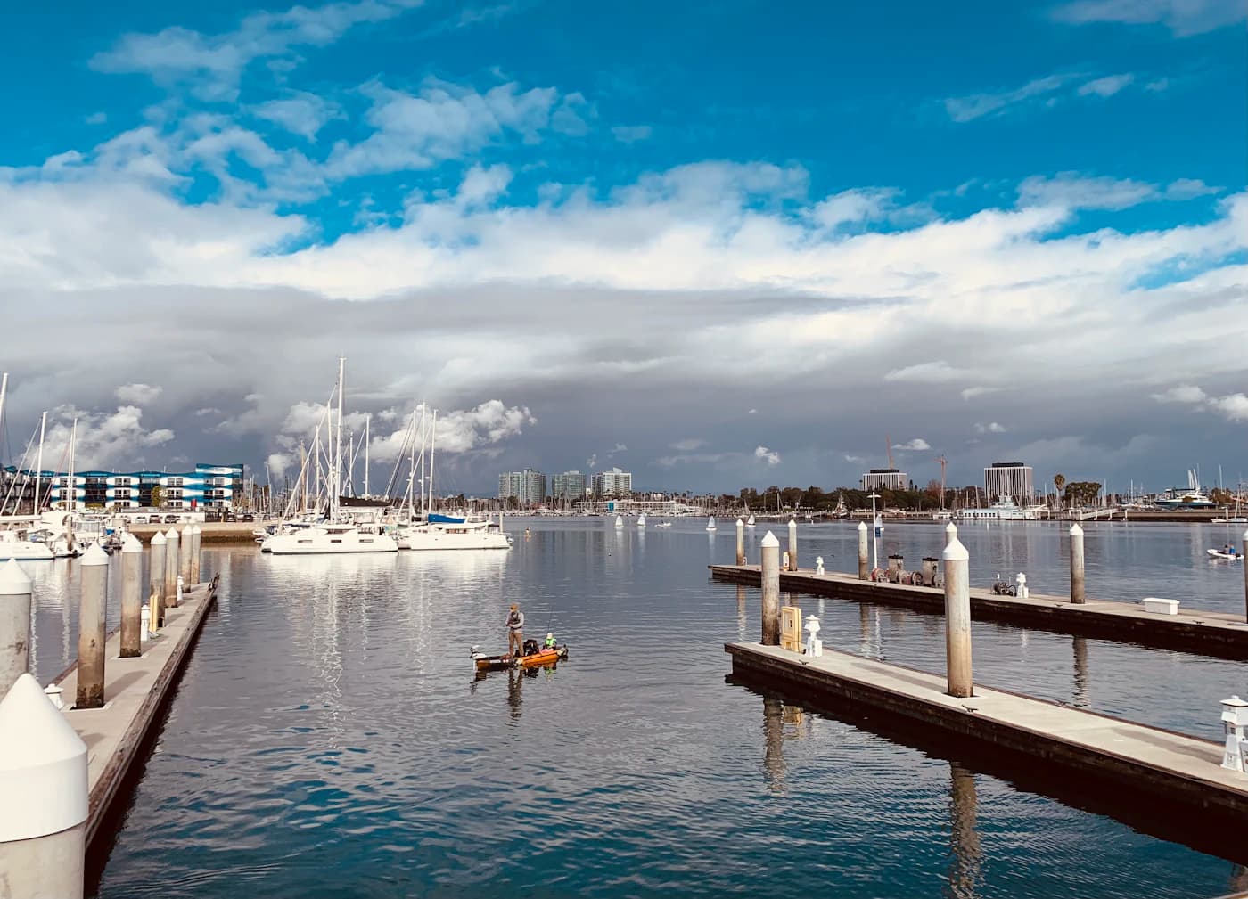 Open Marina del Rey docks with a kayaker crossing the basin