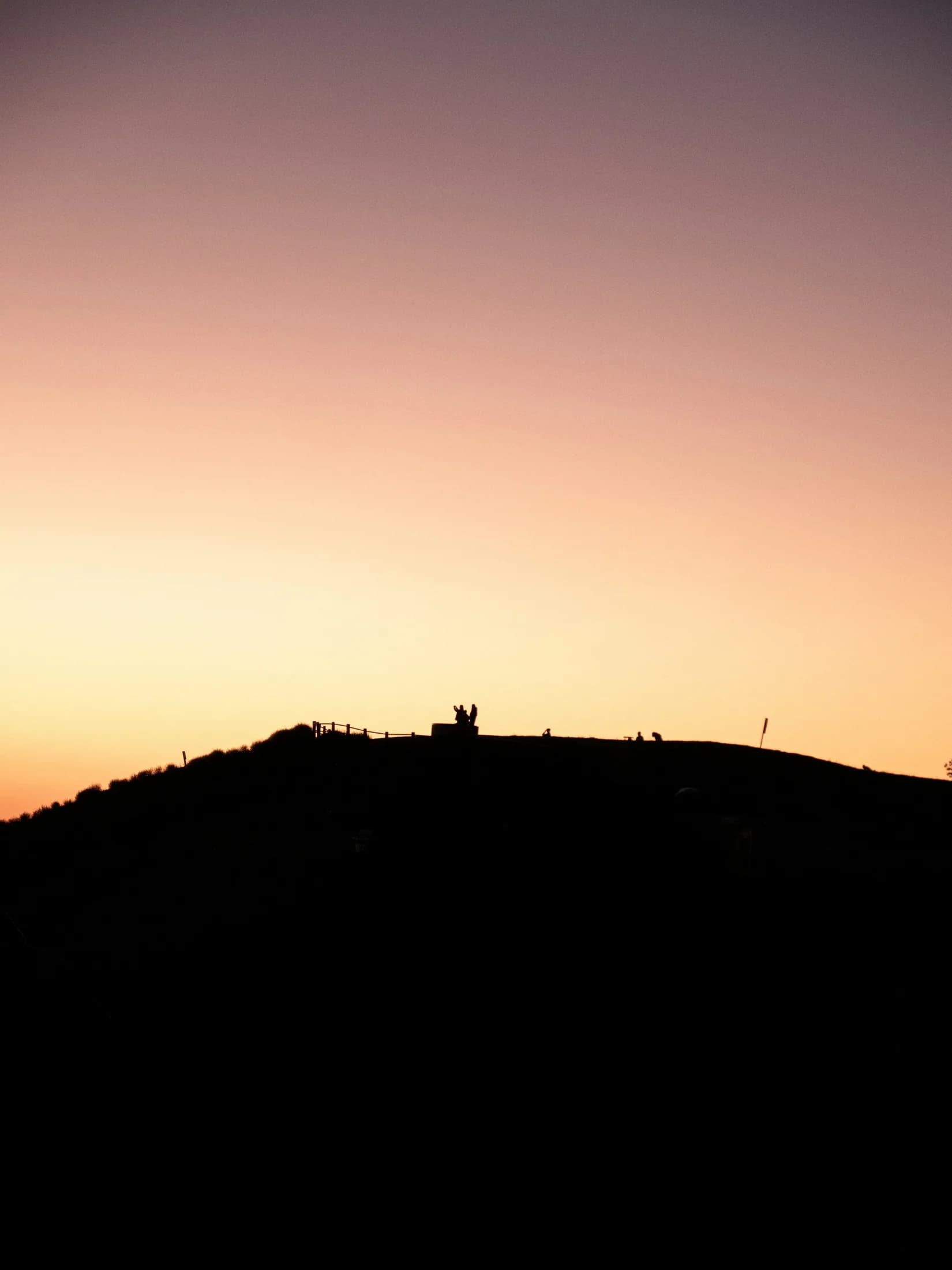 A hiker silhouetted at sunset in Portuguese Bend Reserve
