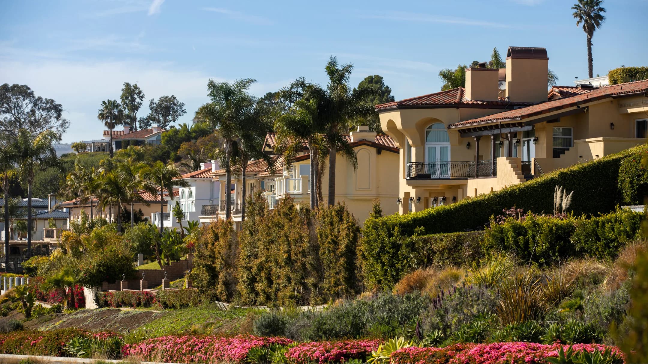 Mediterranean-influenced hillside residences and layered coastal landscaping