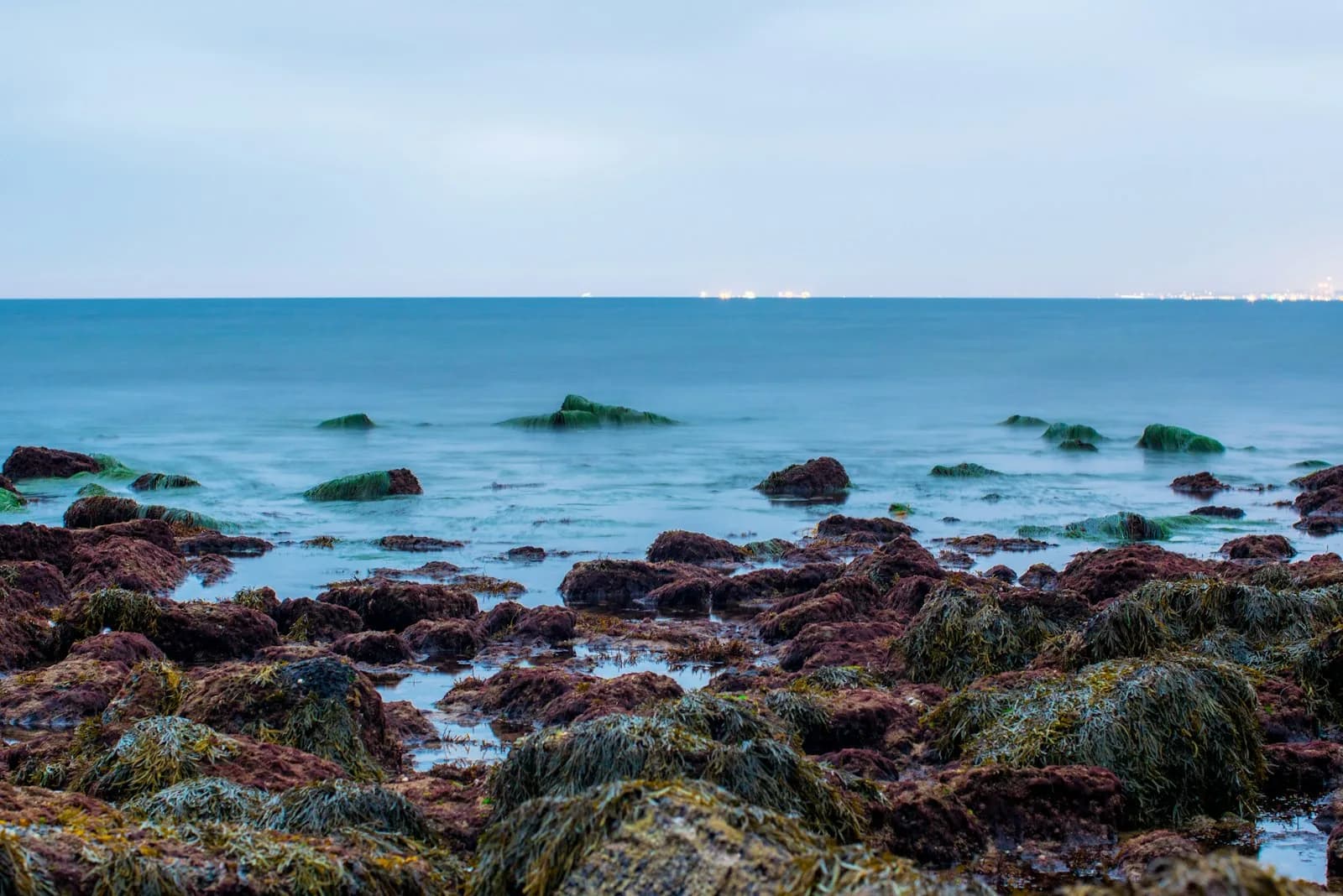Low waves moving through a rocky tide-pool shoreline