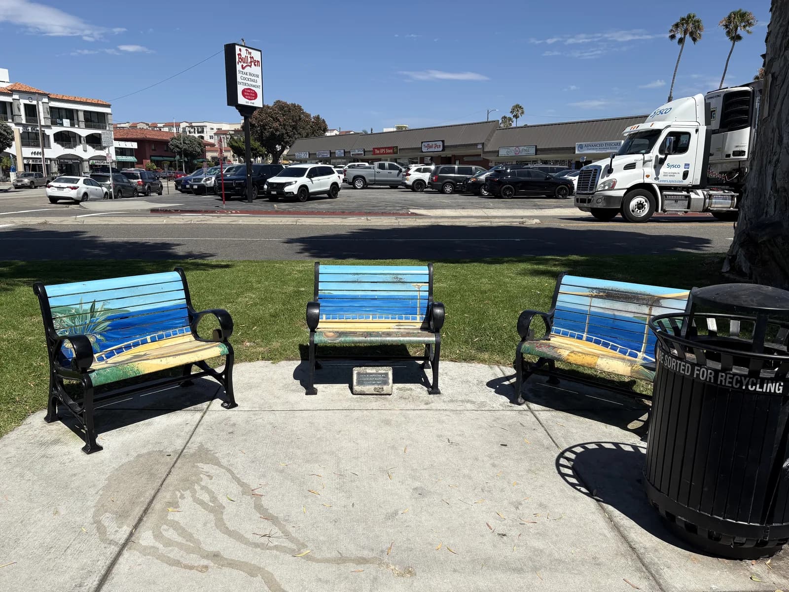 Colorful community benches facing a neighborhood shopping area
