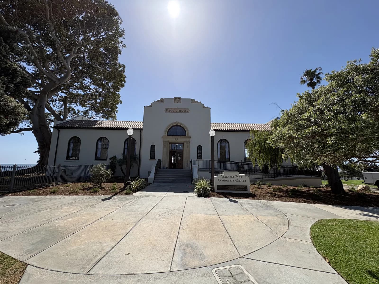 Historic Redondo Beach library building beside mature shade trees