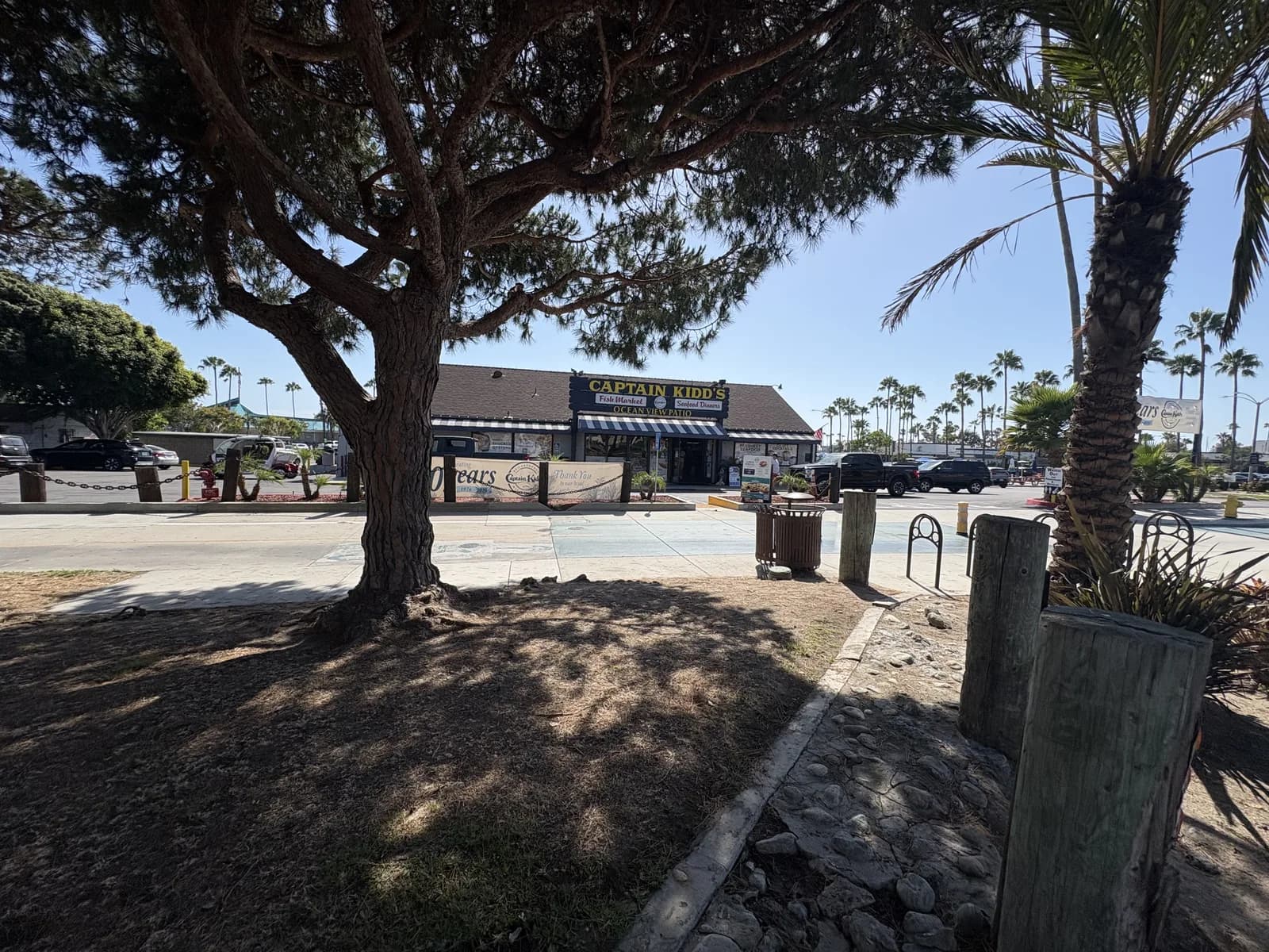 Longstanding seafood market and restaurant beneath a shade tree in King Harbor