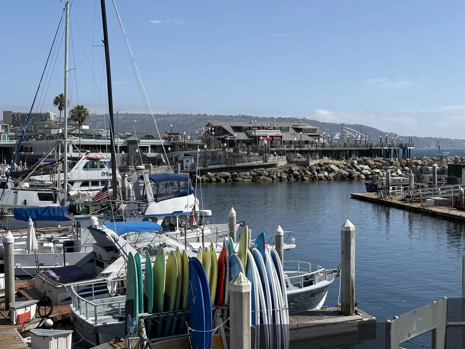 Boats and colorful paddleboards along the King Harbor waterfront