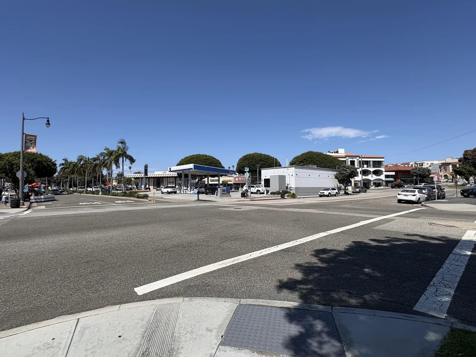 Neighborhood market and palms at a busy Redondo Beach corner