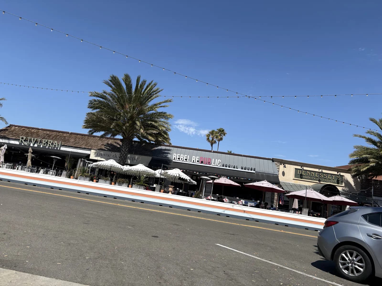 Palm-lined shops and restaurant patios in Riviera Village
