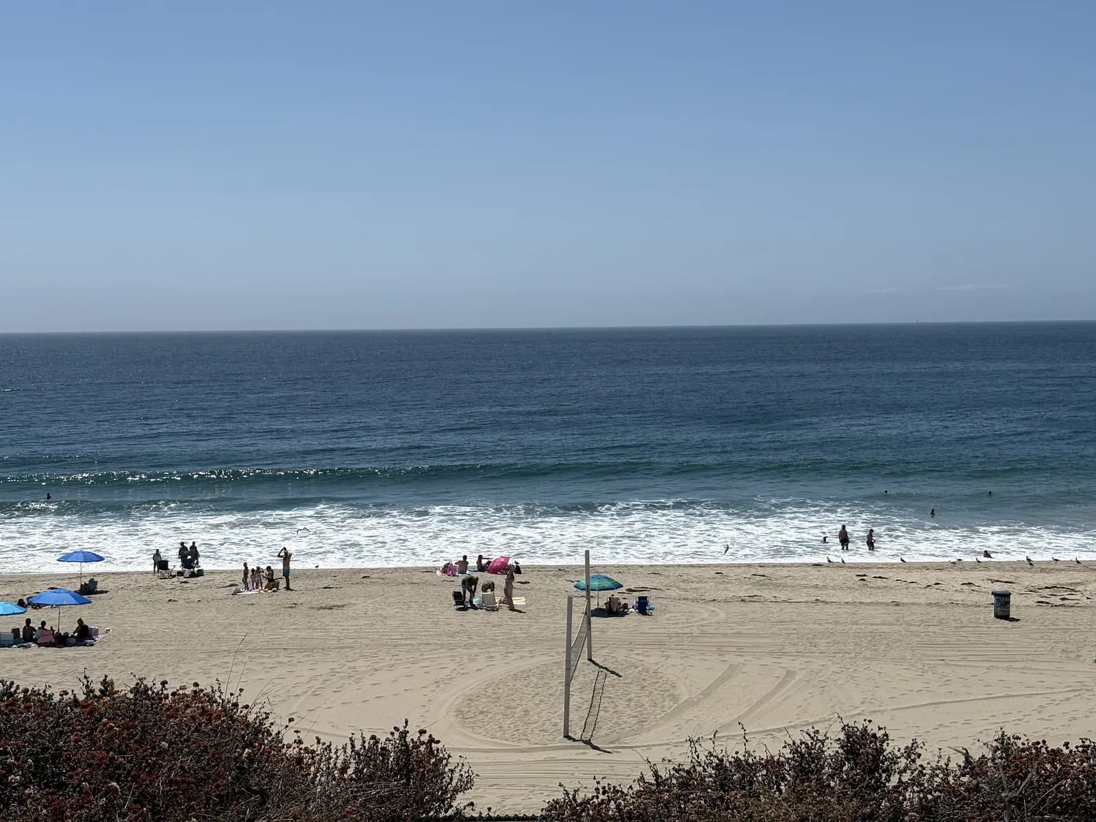 Residents enjoying a calm afternoon on the broad sandy beach