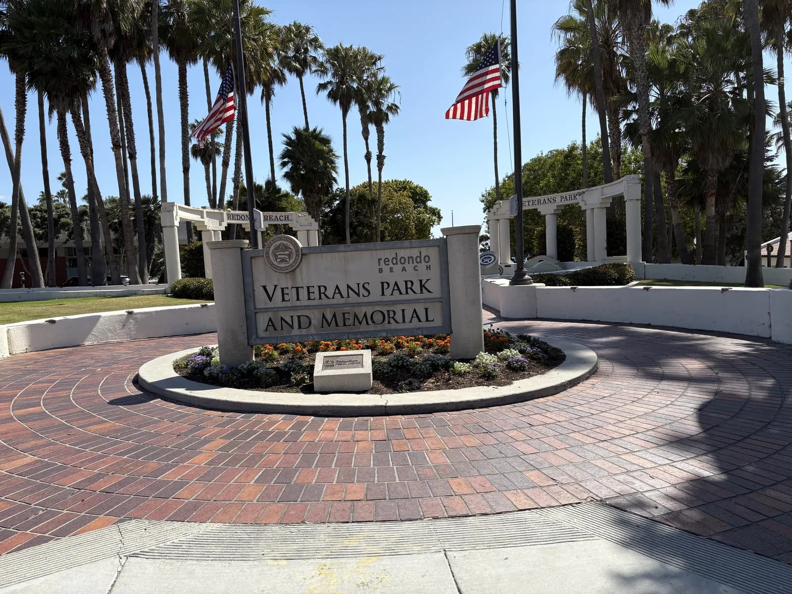 Veterans Park and Memorial entrance framed by palms and flags