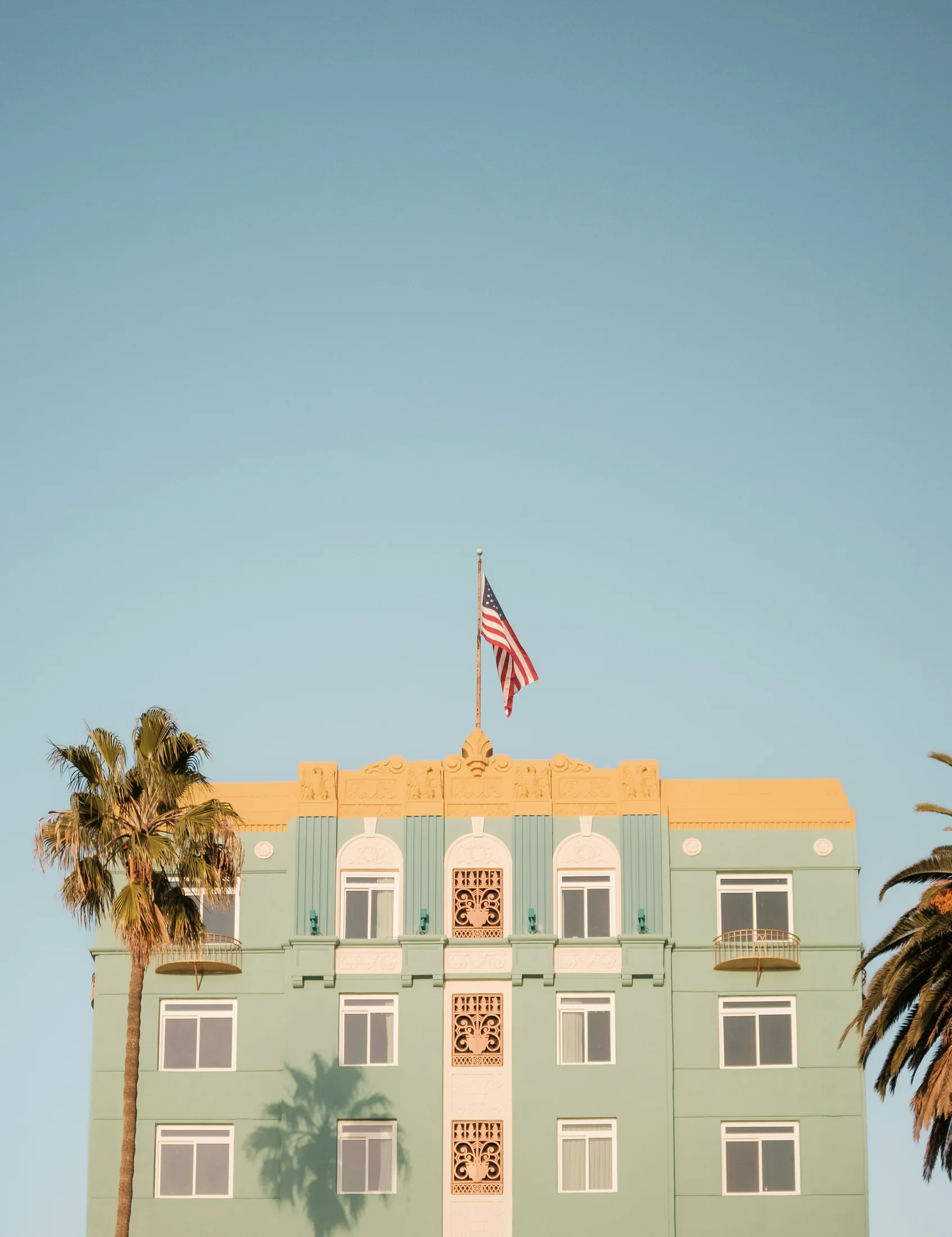 The Georgian Hotel facade catching clear daylight on Ocean Avenue