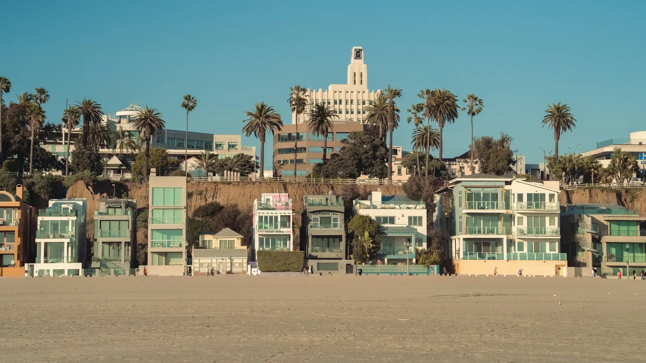 Colorful beachfront homes and palms along Santa Monica Beach