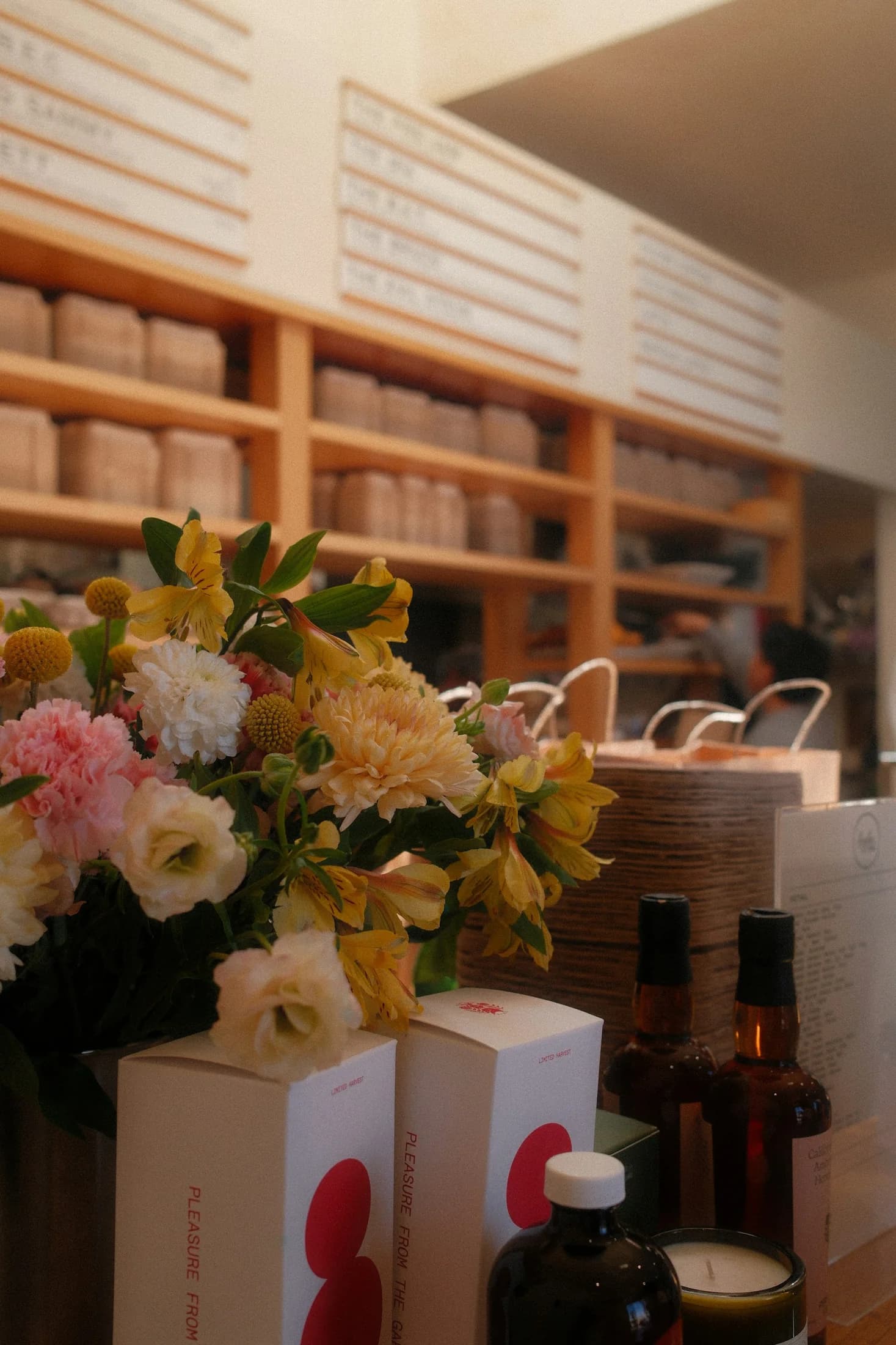 Flowers and goods arranged on the counter of a Santa Monica cafe