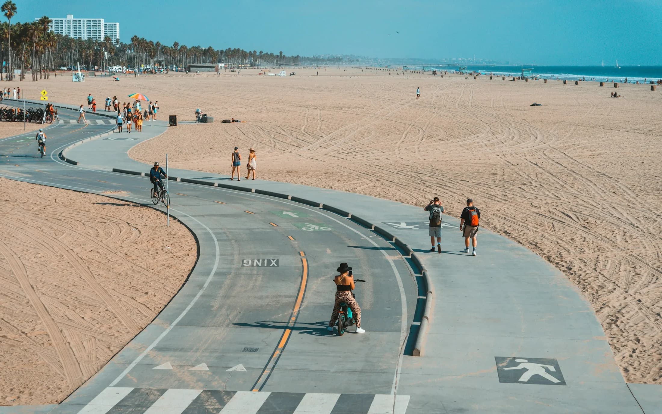 Cyclists traveling along a Santa Monica street near the coast