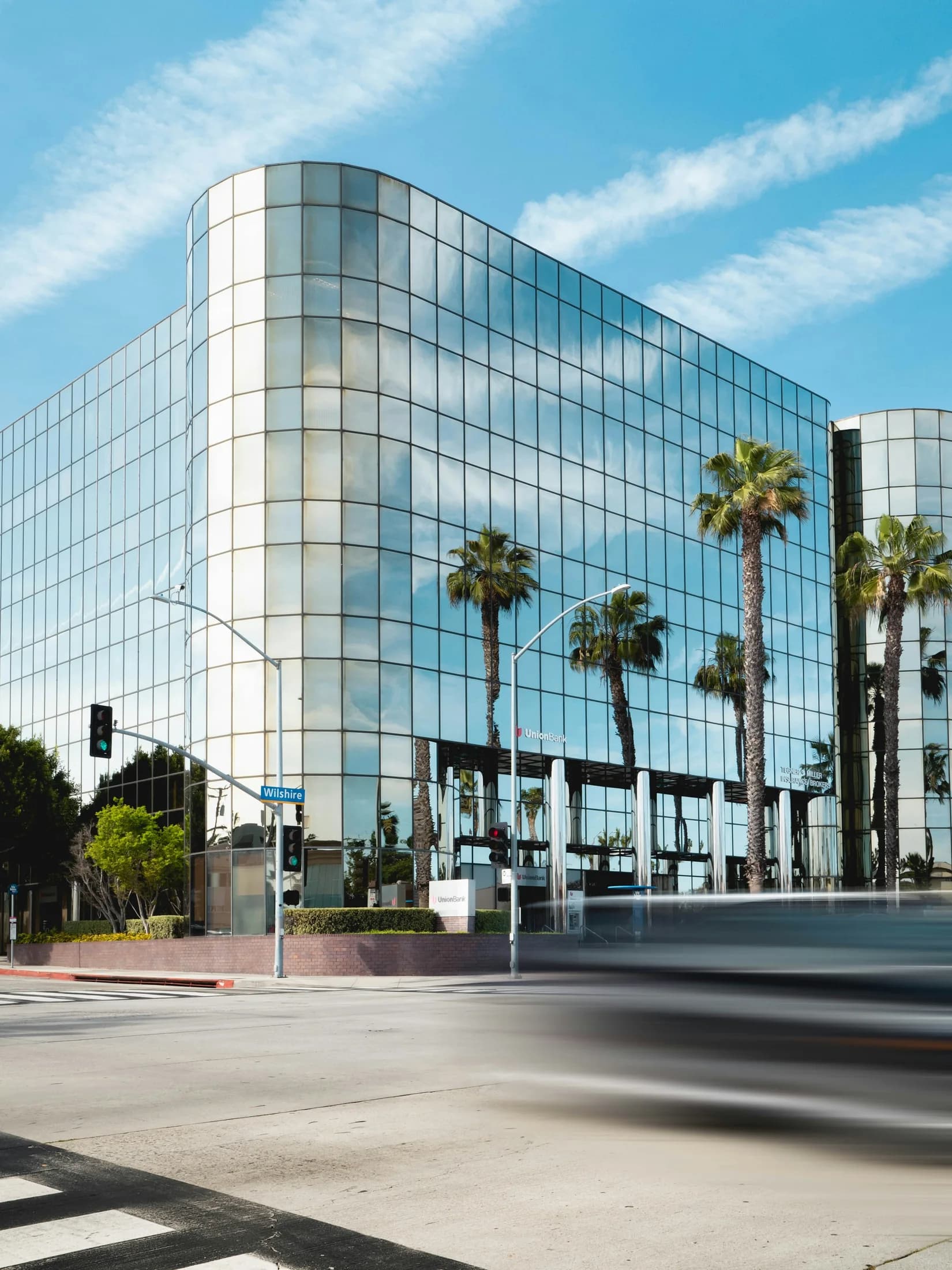 A glass office building and palms in Santa Monica
