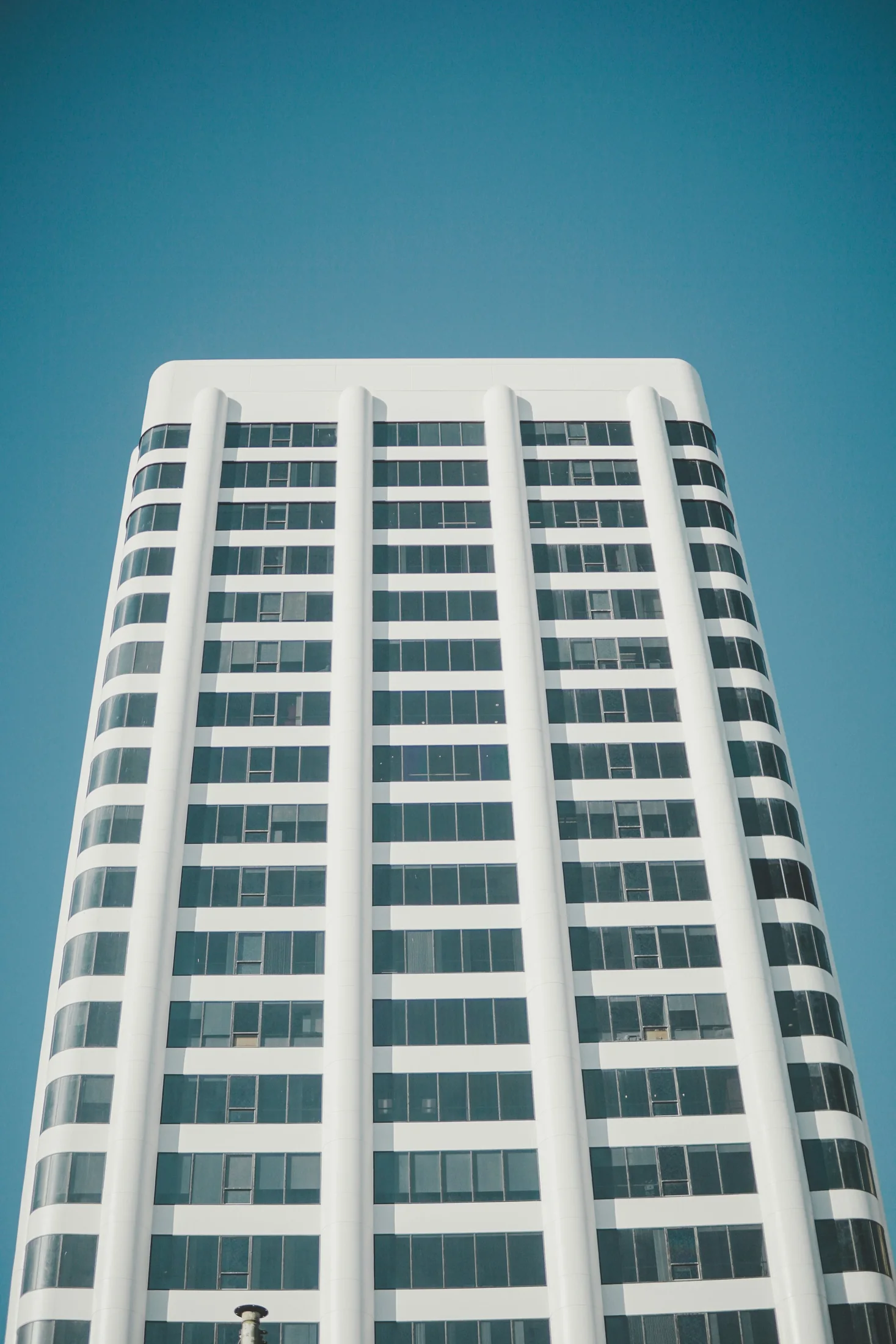 A white Santa Monica high-rise framed by a clear blue sky