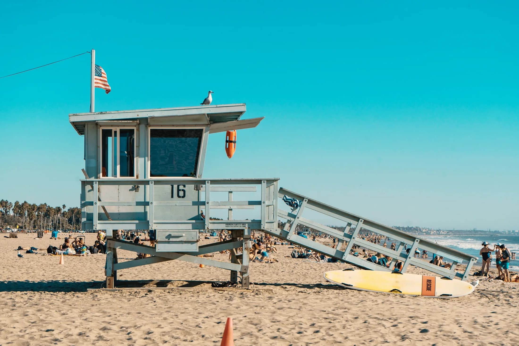 A Santa Monica lifeguard tower standing above the sand and Pacific Ocean