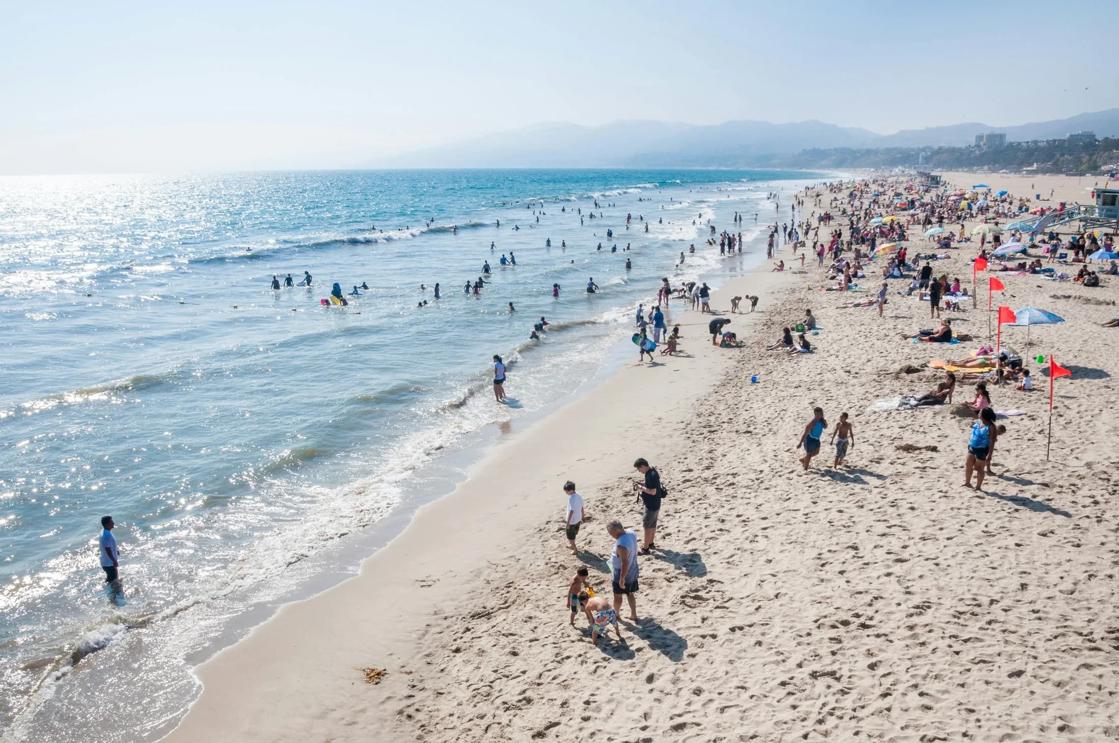 Beachgoers along Santa Monica State Beach viewed from the pier