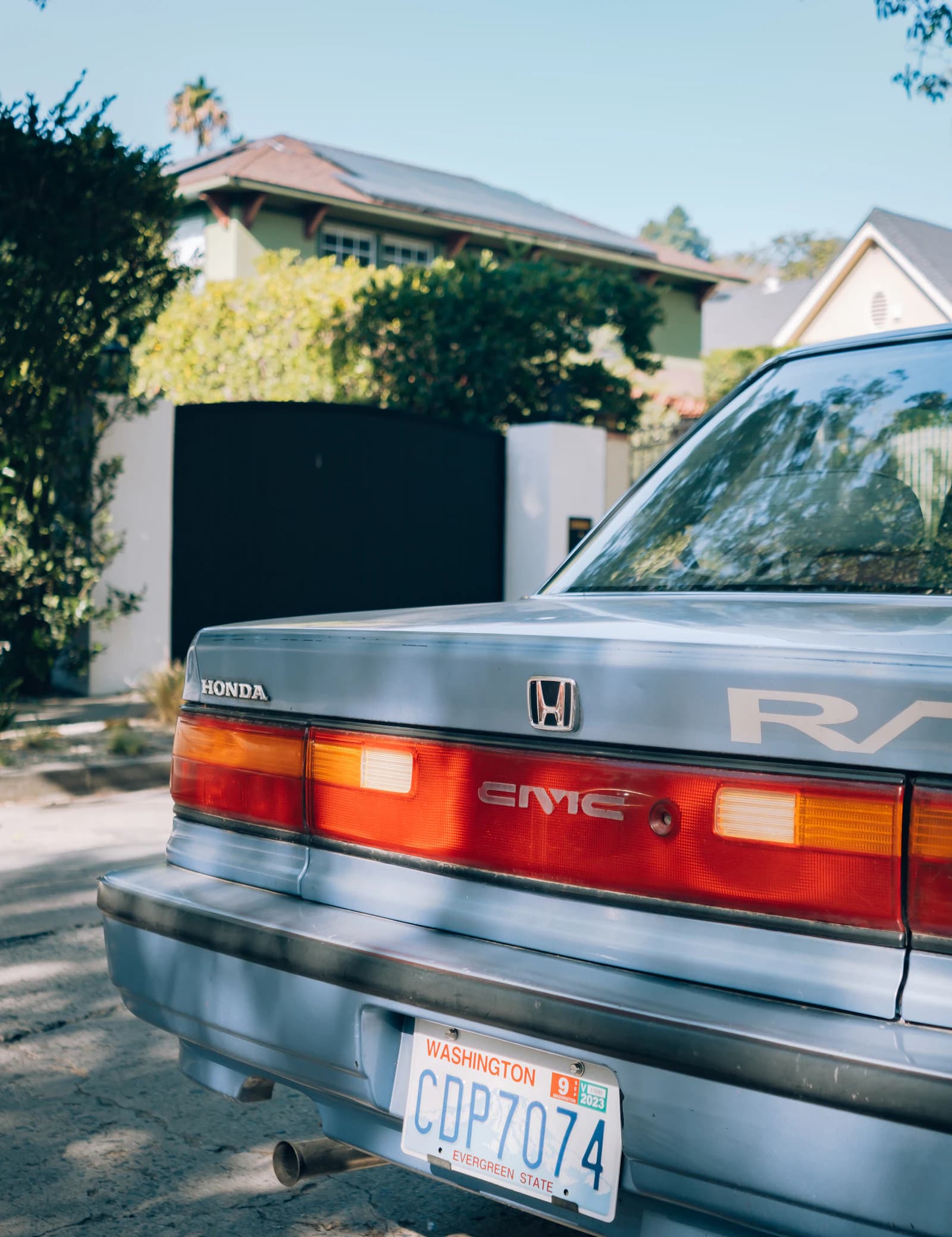 A vintage car parked beside low-rise Los Angeles homes