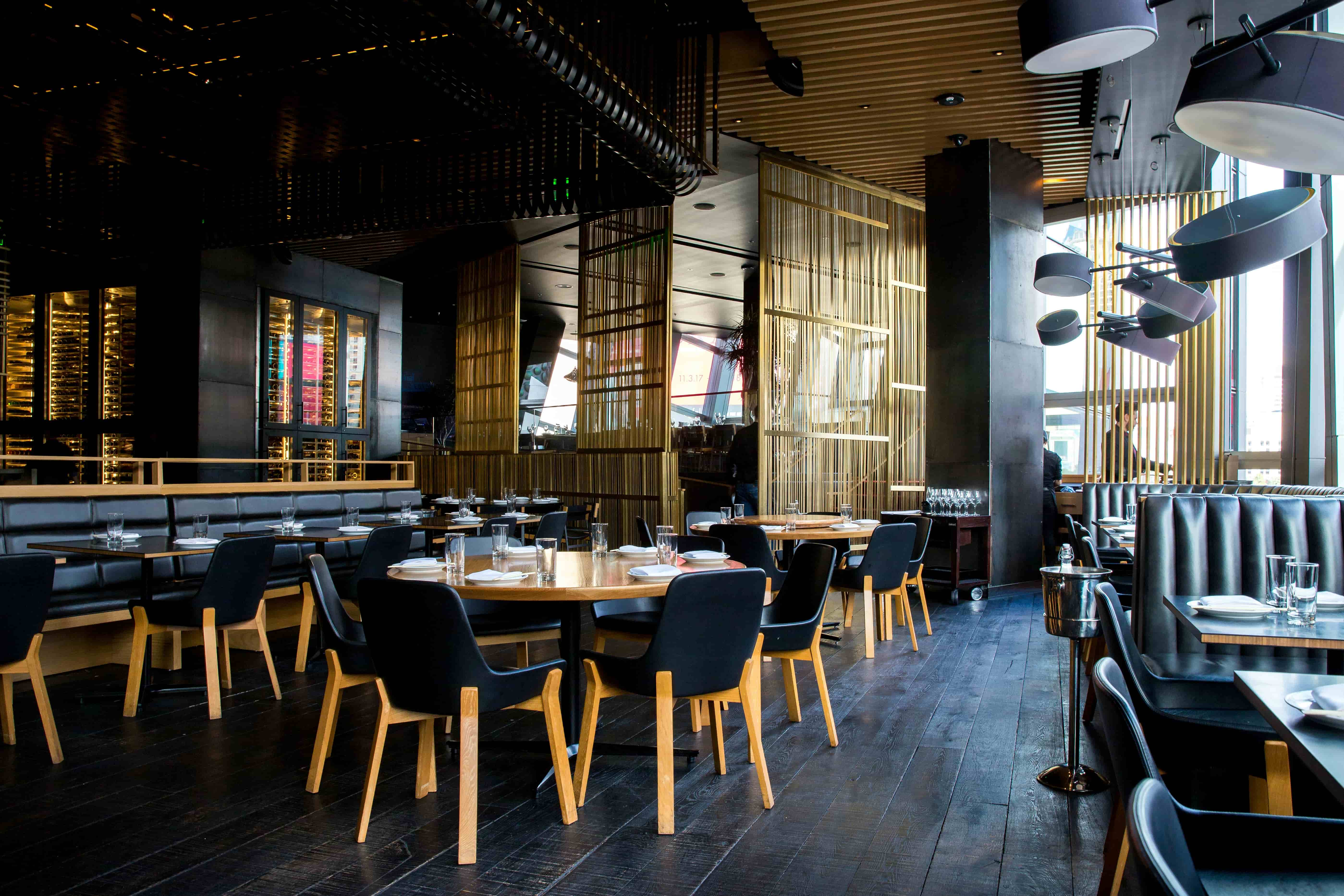 A warm, contemporary dining room prepared for evening service