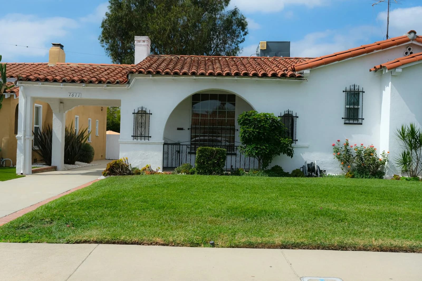 A single-story Spanish bungalow with a red tile roof