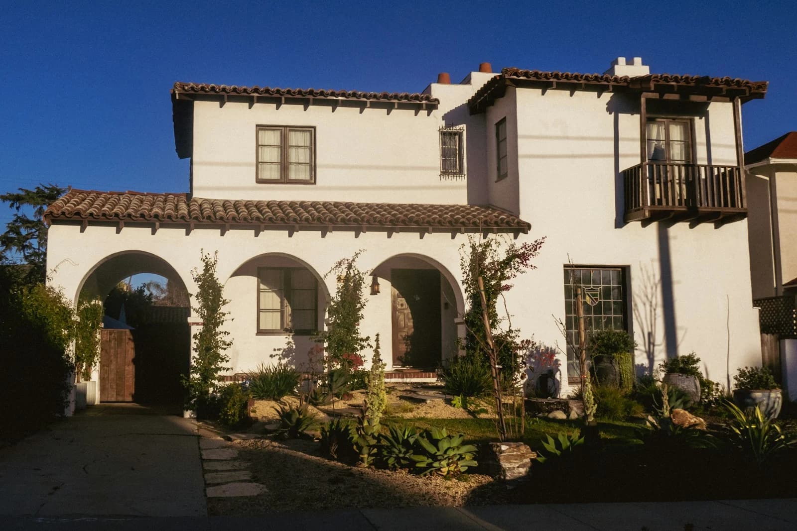 A Spanish-style home with an arched front entry