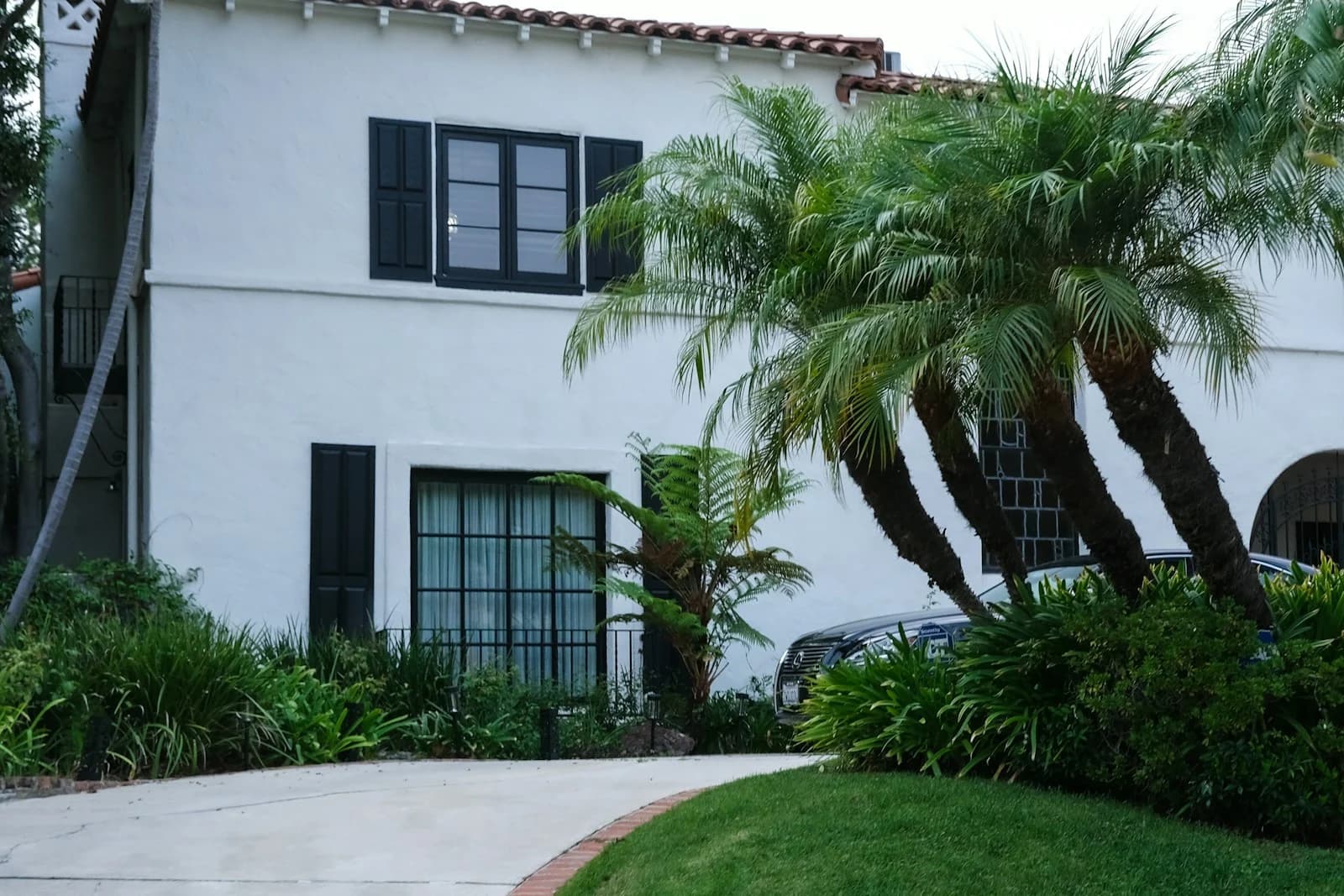 A Spanish-style home set among mature palms