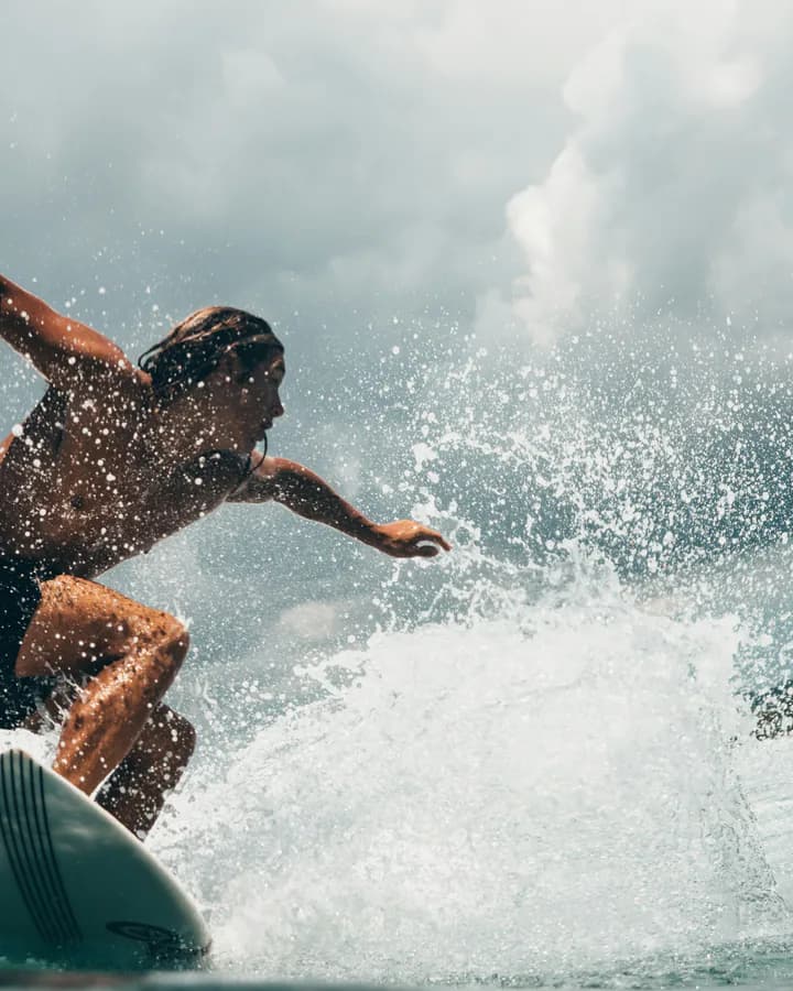 Surfer riding a modest wave along the Southern California coast