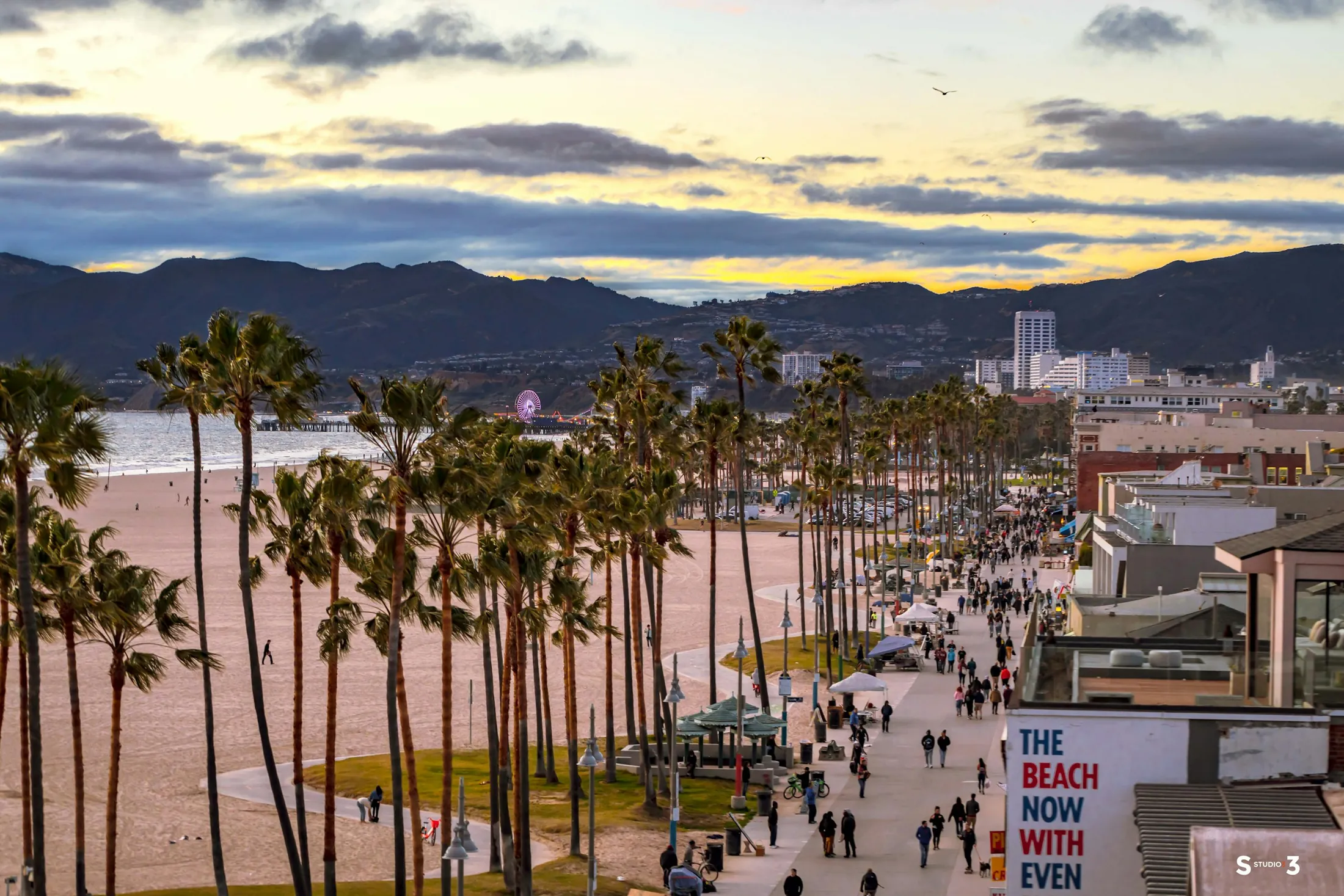 Palms, beach paths, and evening activity across Ocean Front Walk