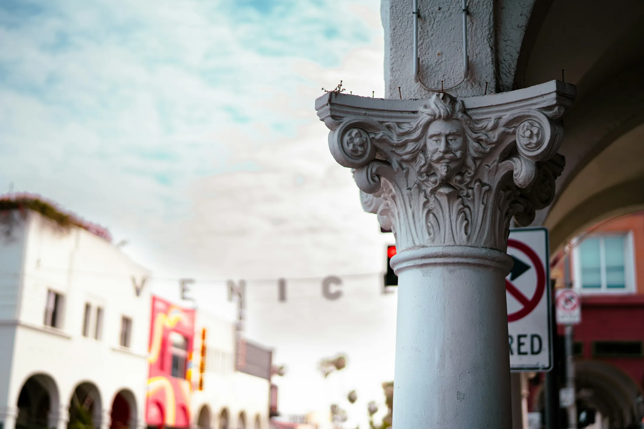 Decorated columns and public art along a Venice shopping street